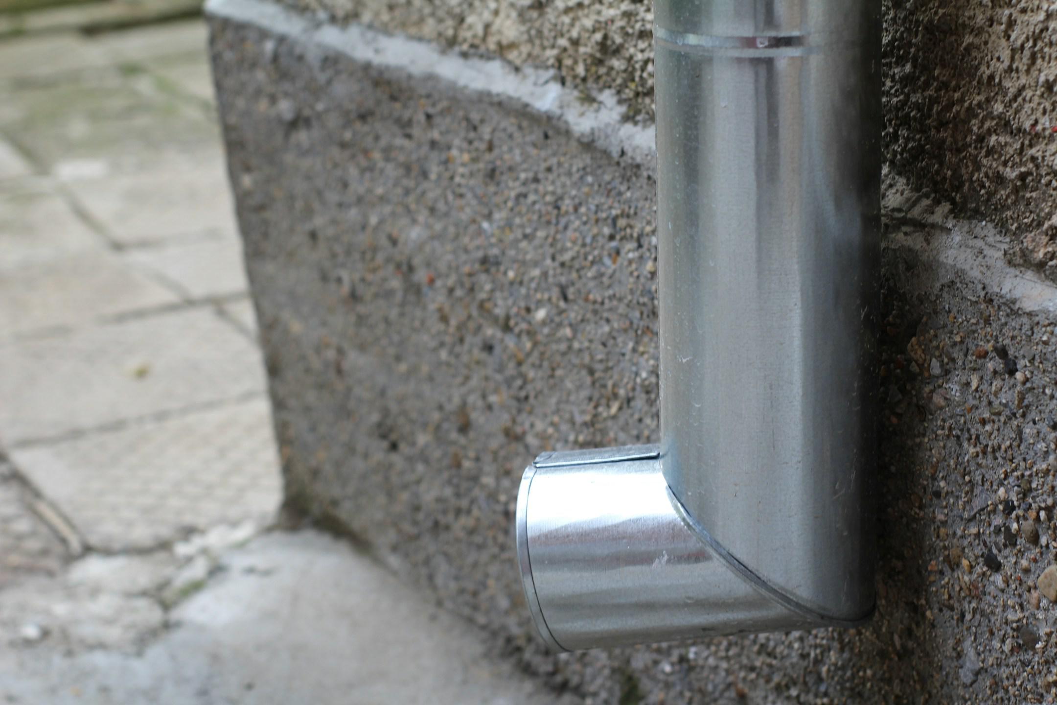 A metal rain gutter pipe.