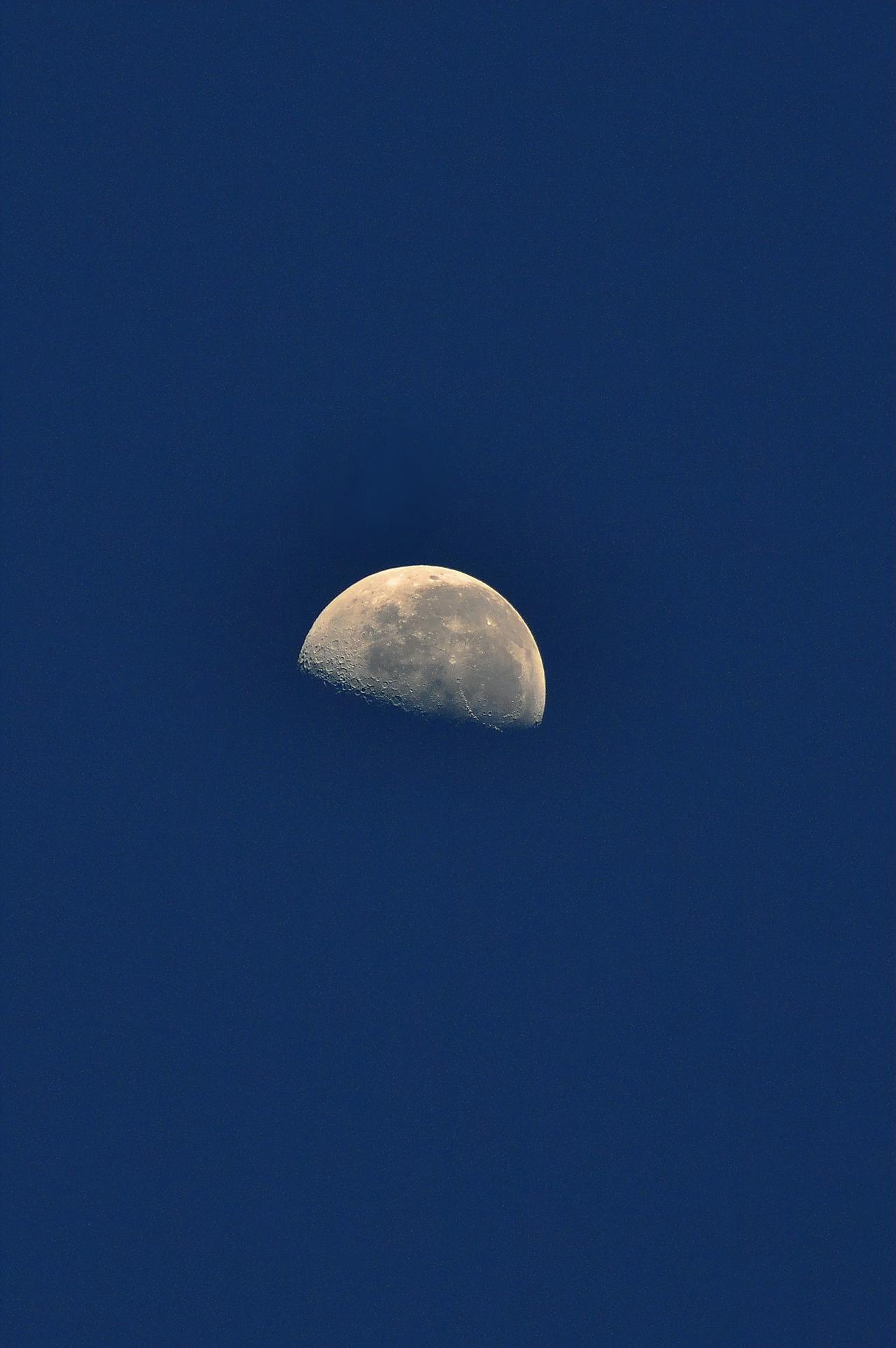 Super full moon with dark background. Moscow, Russia. Vertical photography.
