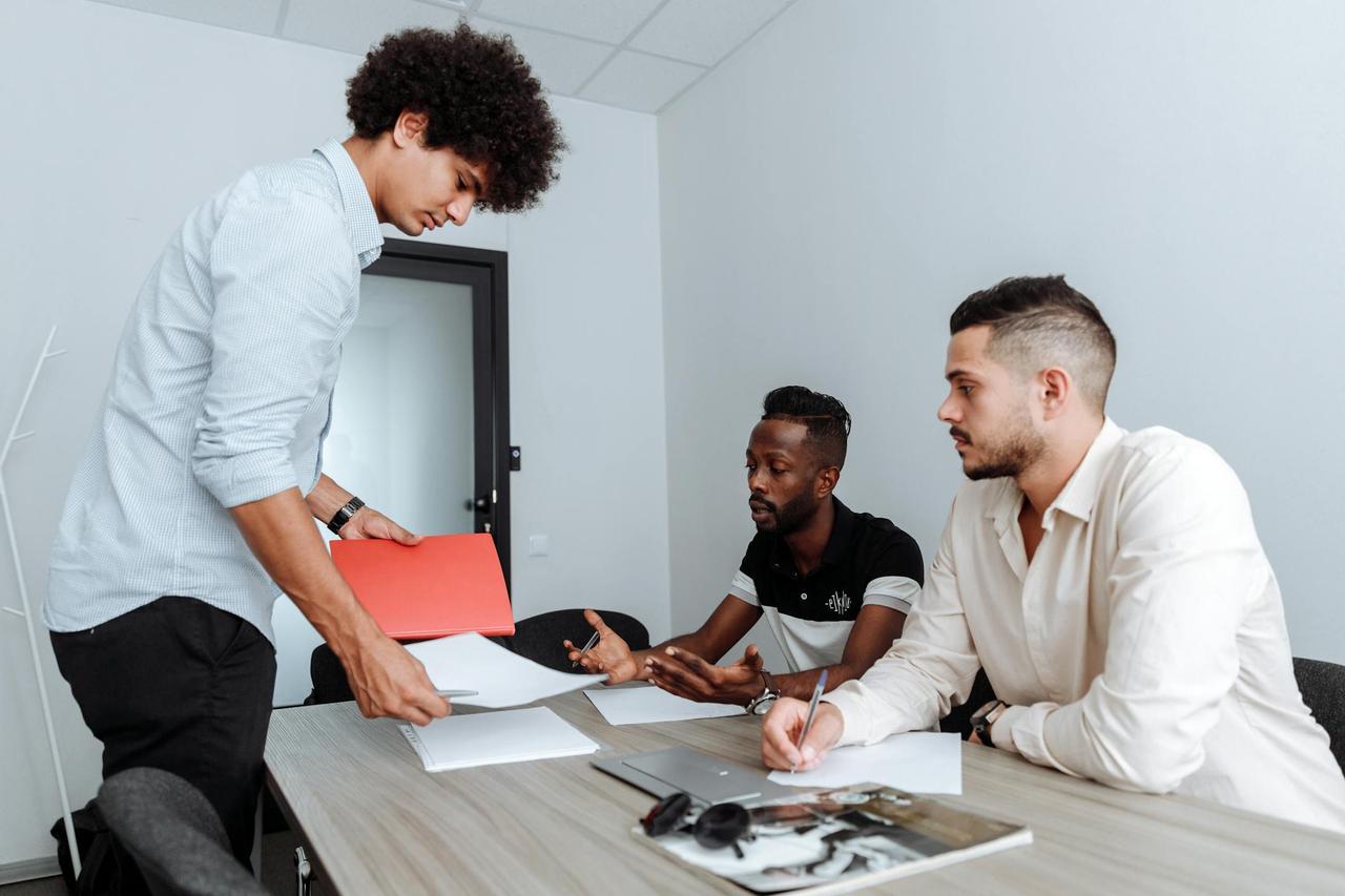 A diverse business team engaged in a creative work session in a modern office setting.