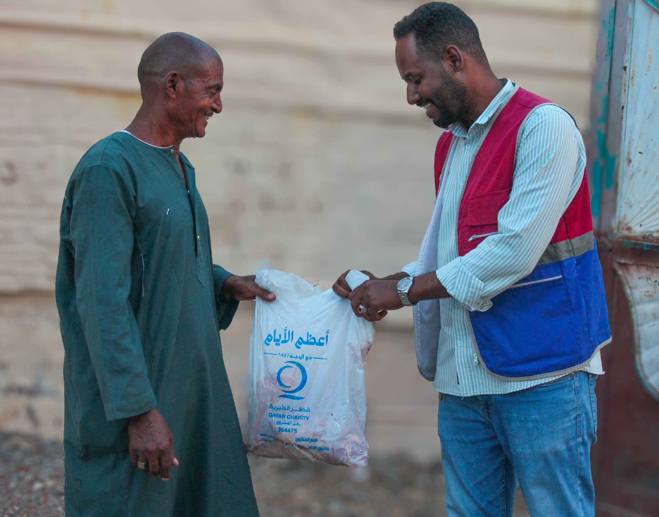 Man giving another man a bag with fresh meat