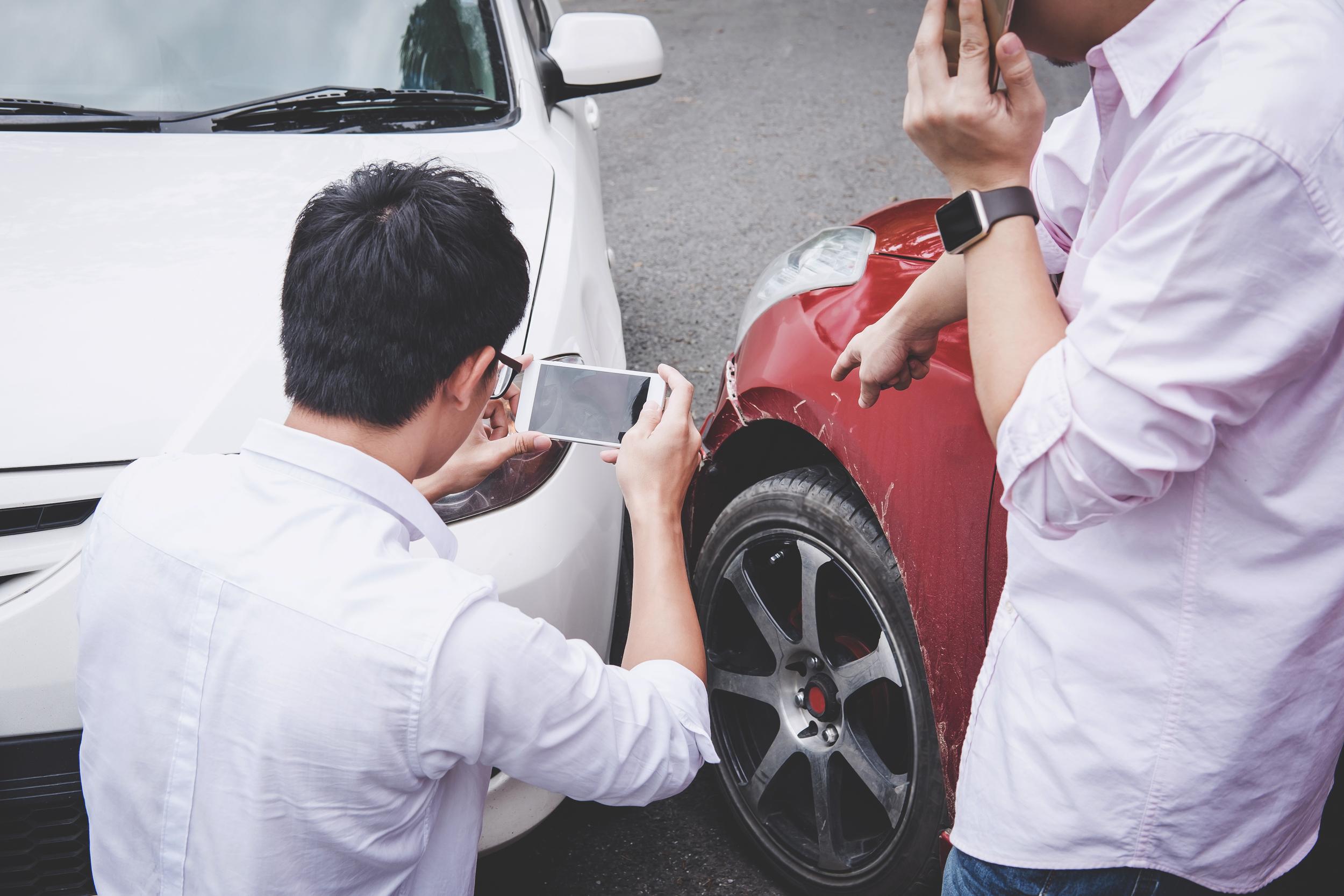 aftermath-of-auto-accident-two-men-inspect-damage-2026-09-23-01-23-08-utc.jpg