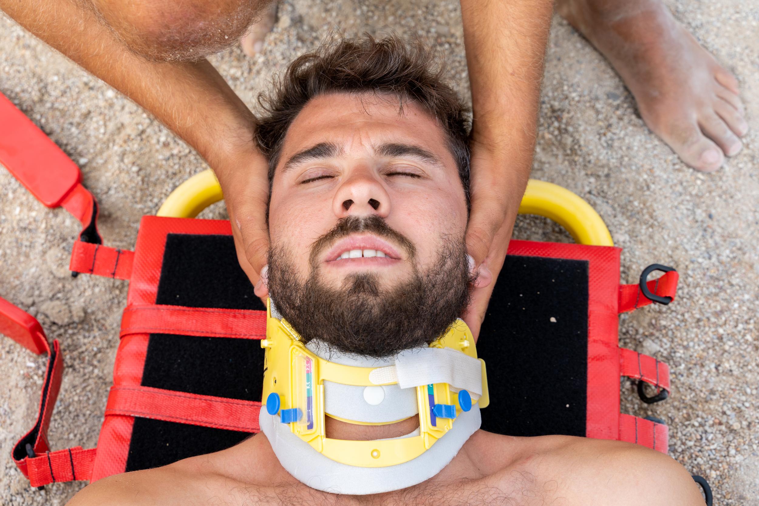 man-lying-on-stretcher-with-neck-brace-2026-09-23-01-49-35-utc.jpg