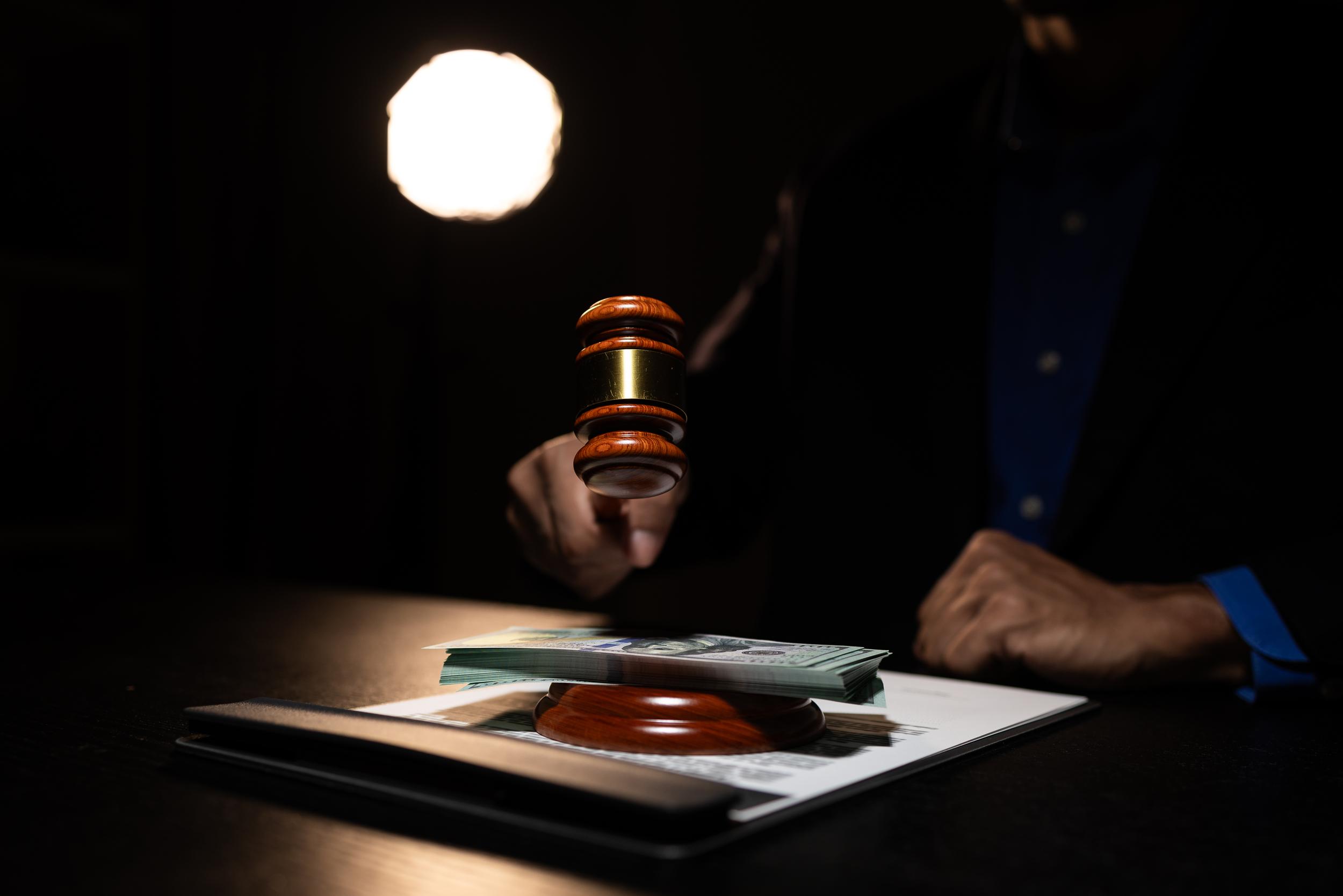 gavel-hovering-above-money-on-the-table-2026-09-24-14-05-35-utc.jpg