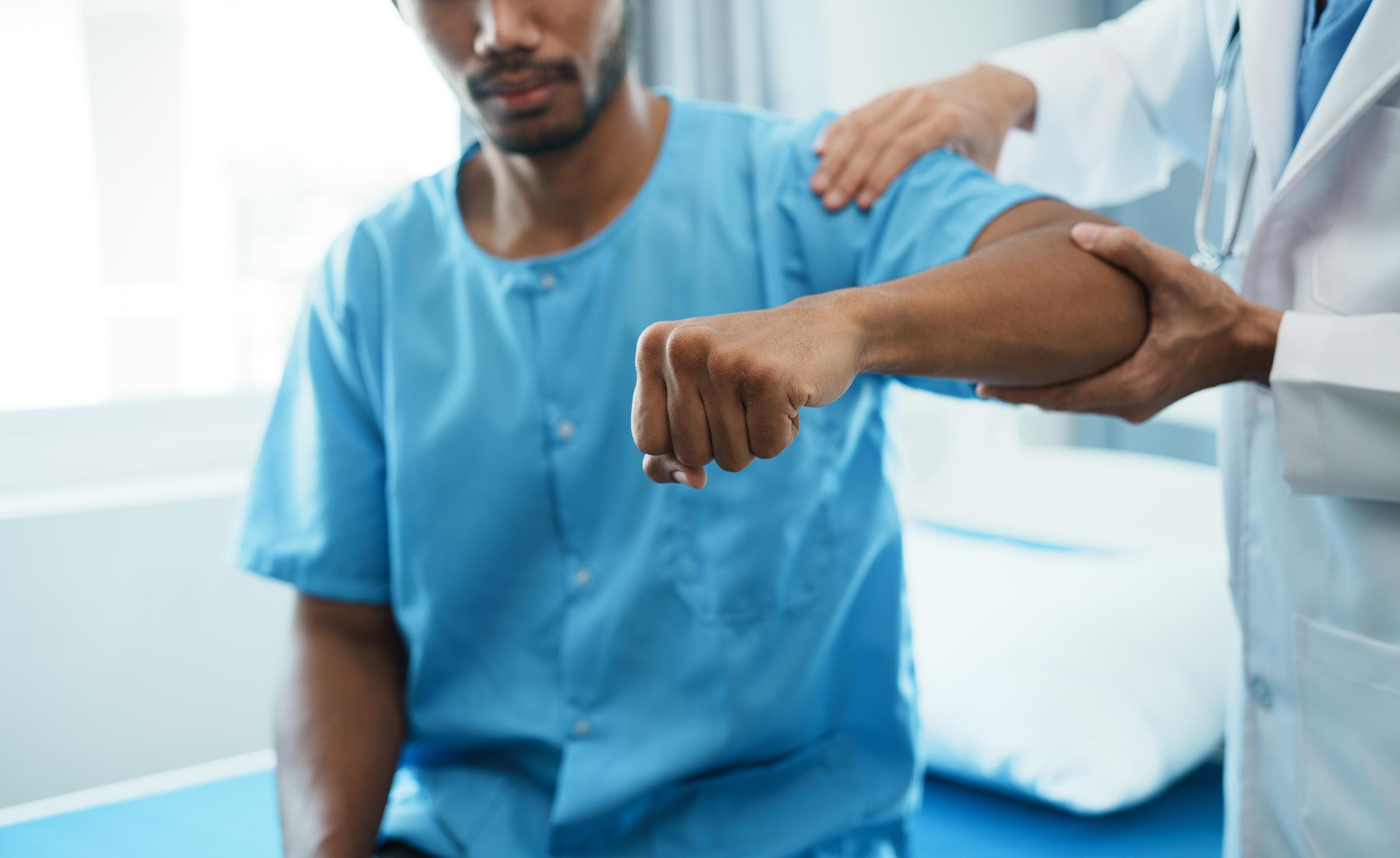 physical-therapist-examining-arm-of-male-patient-2026-09-21-12-46-10-utc.jpg