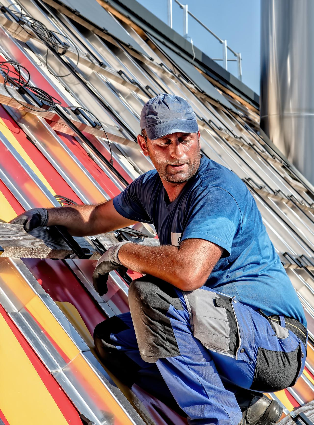 Man at work on the installation of solar panels