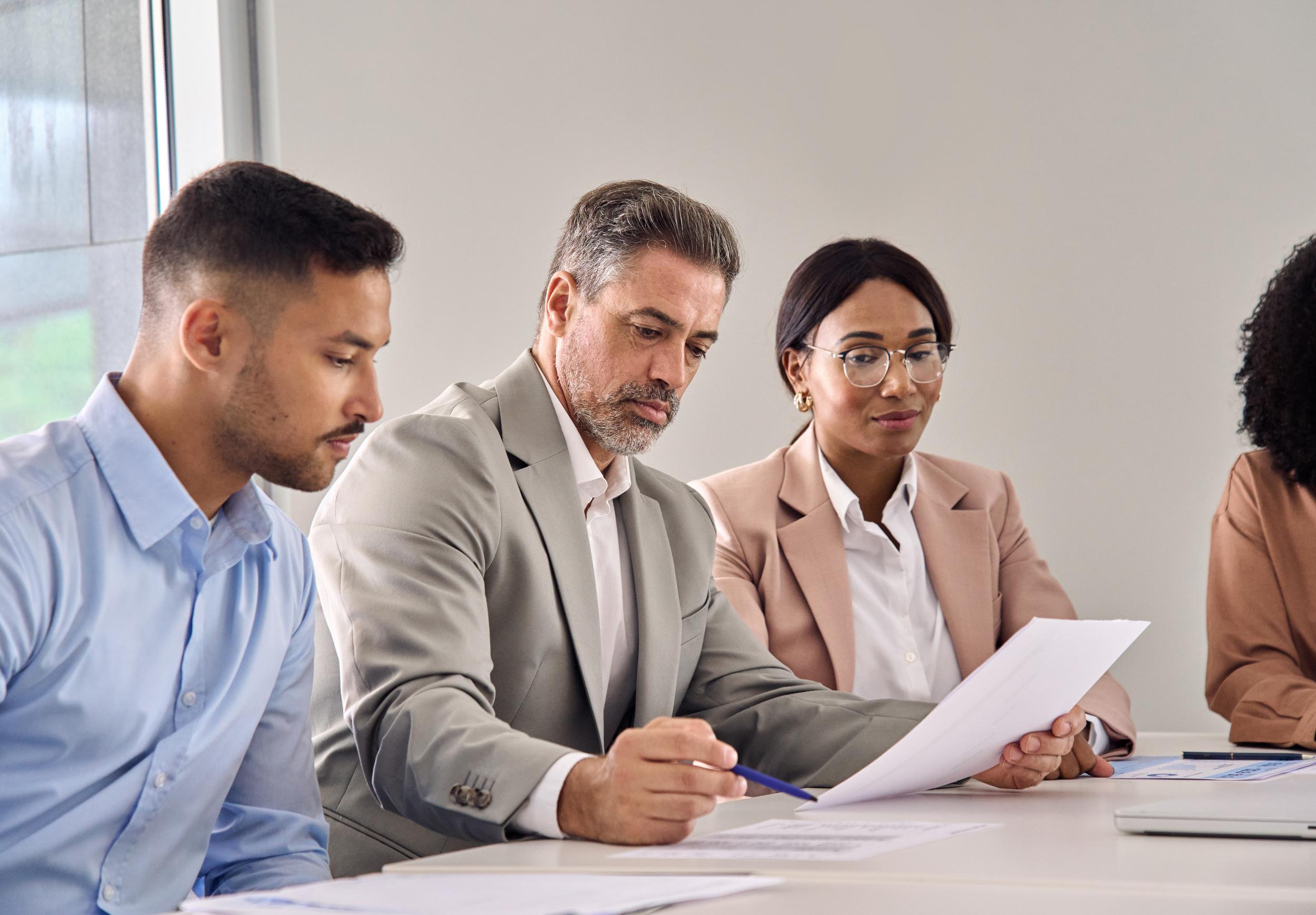 6d93e08c-fe9c-11ef-a10b-0242ac110002-serious-business-man-checking-document-at-meeting-2025-02-11-16-19-20-utc.jpg