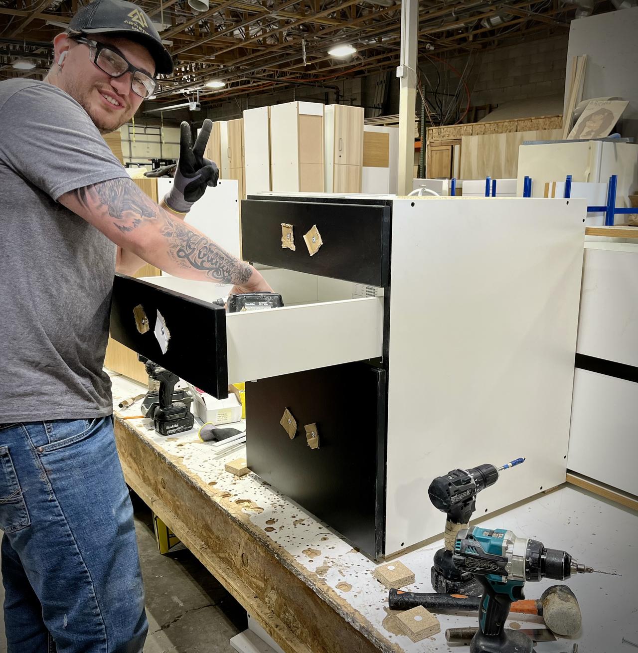 Production millwork workstations with partially completed cabinetry components