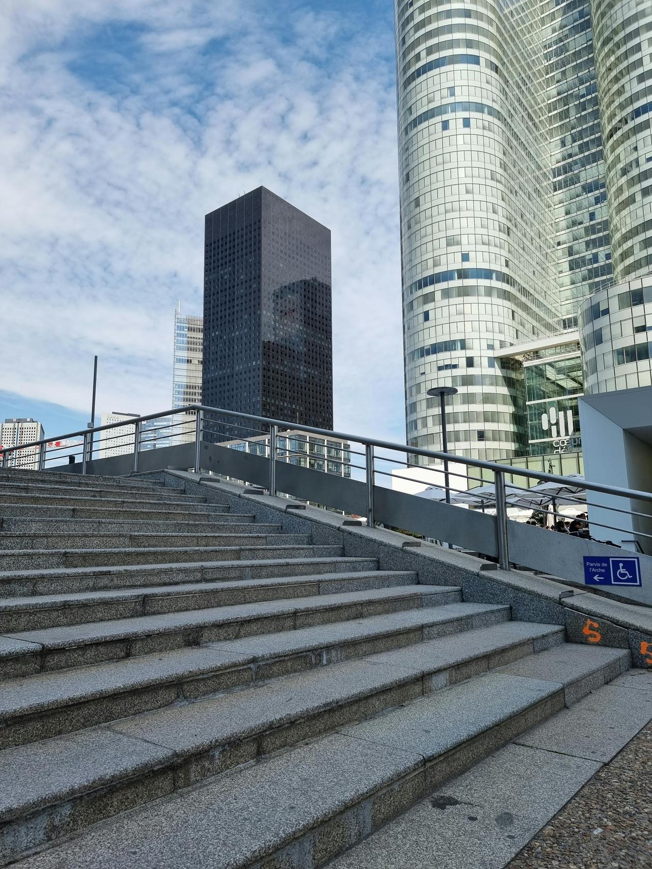 Stunning view of La Défense skyscrapers and stairs, capturing modern architecture.