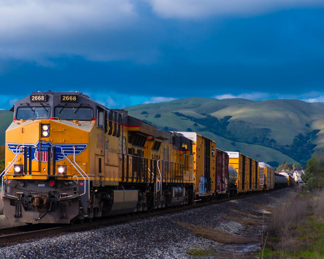 I loved the analagous colors formed by the yellow train, green hills, and blue sky. I love the country feel this photo has with the rolling green hills in the background and the freight train coming right through.
