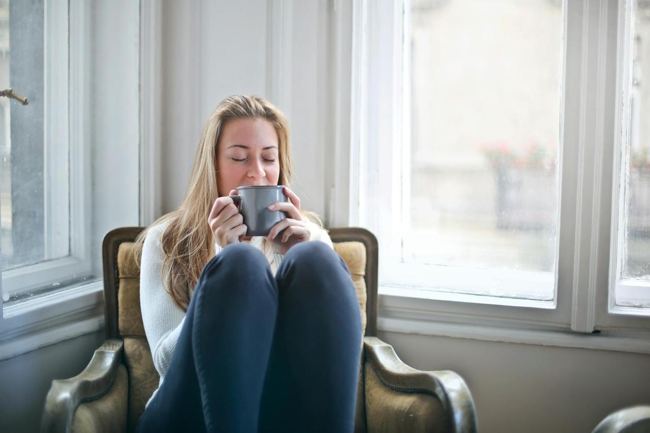 Woman enjoying a warm drink in a cozy armchair by a window, embracing relaxation.Mystic Cleaning Co provides top-quality residential and commercial cleaning services in Conroe, The Woodlands, Magnolia, and Willis. Our team specializes in general cleaning, deep cleaning, and move-in/move-out services, using professional equipment and attention to detail.