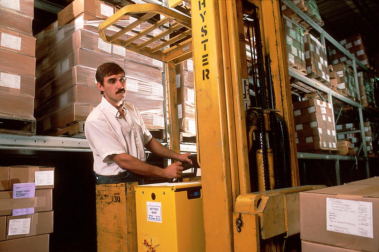 A man driving a forklift.