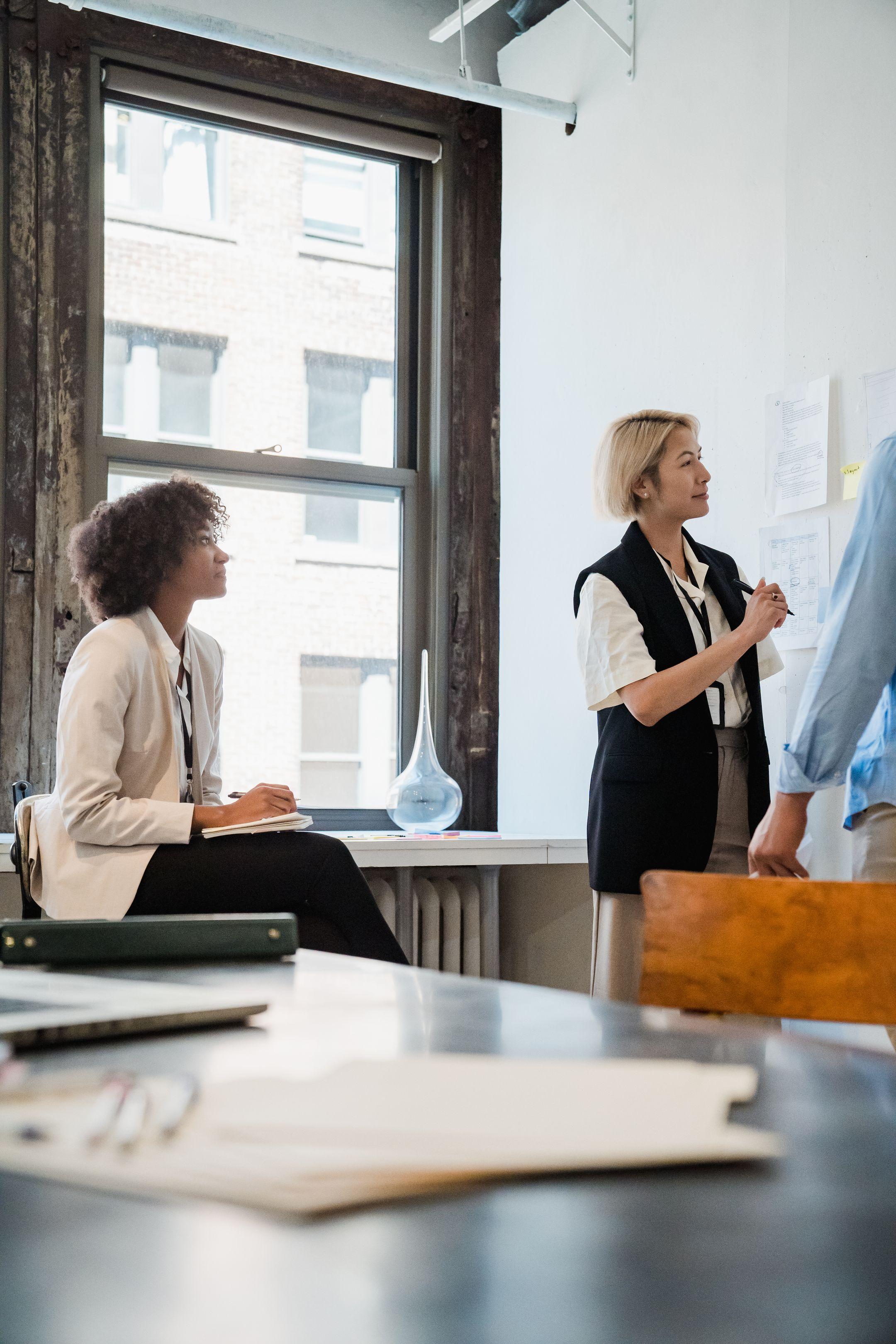 Professional team collaborating on a project in a well-lit office space.