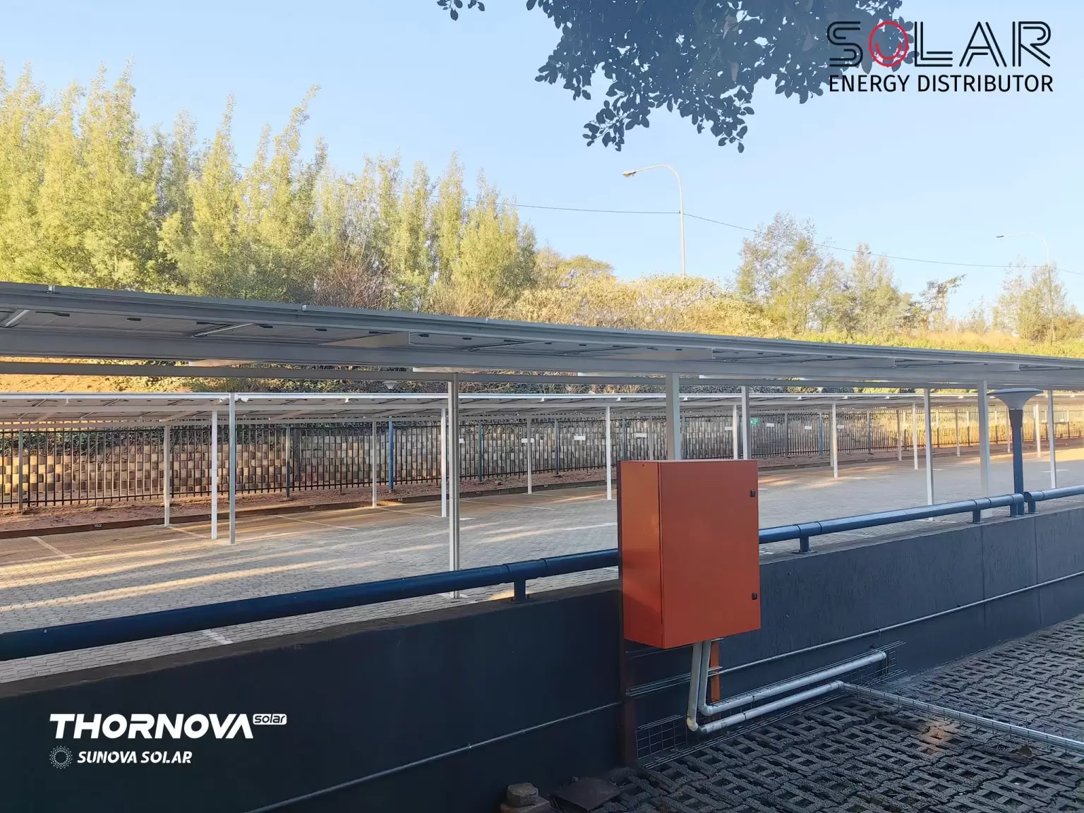 Overhead view of carport with solar panels and parked vehicles