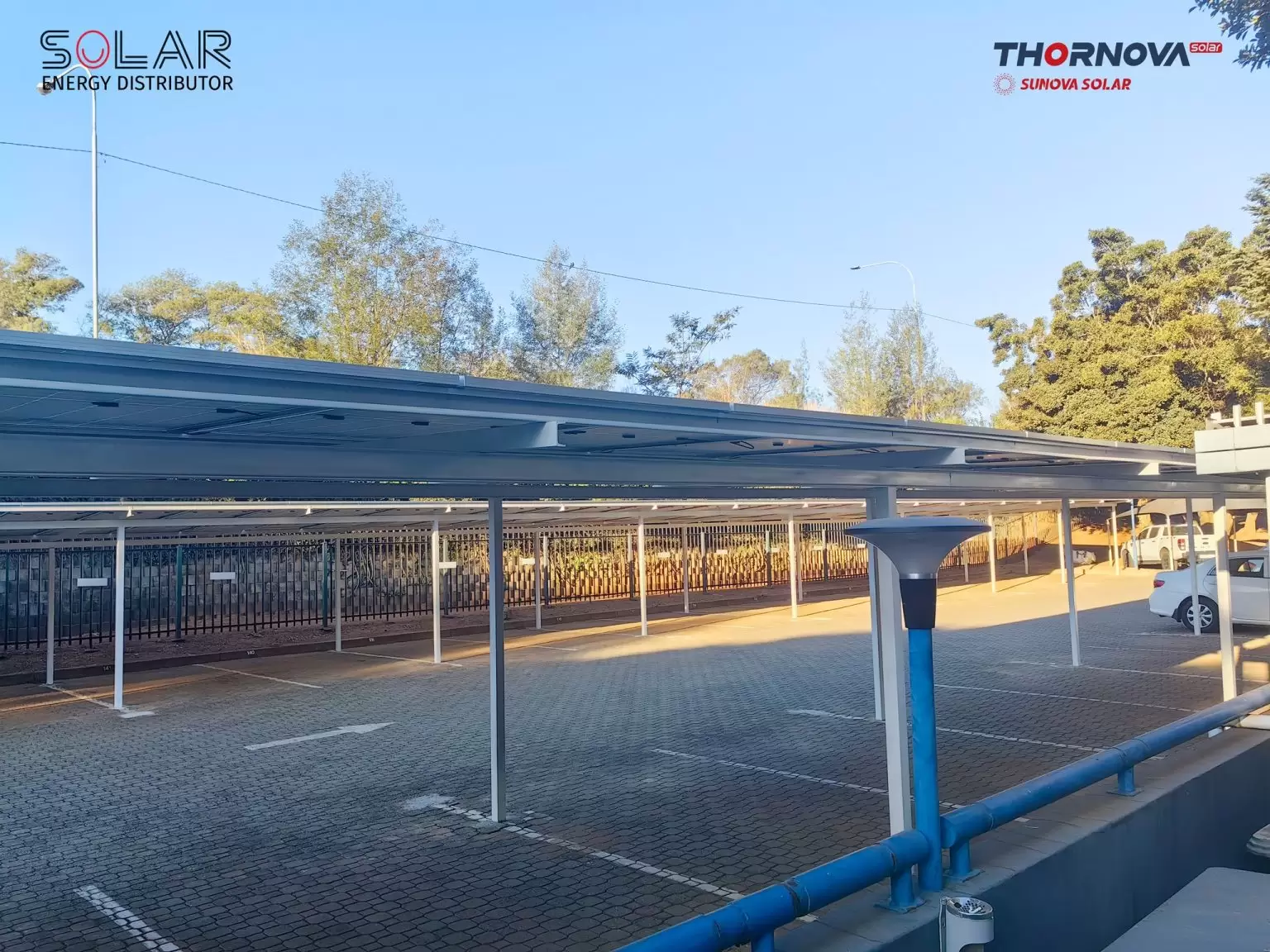 Professional solar installation team working on carport panels