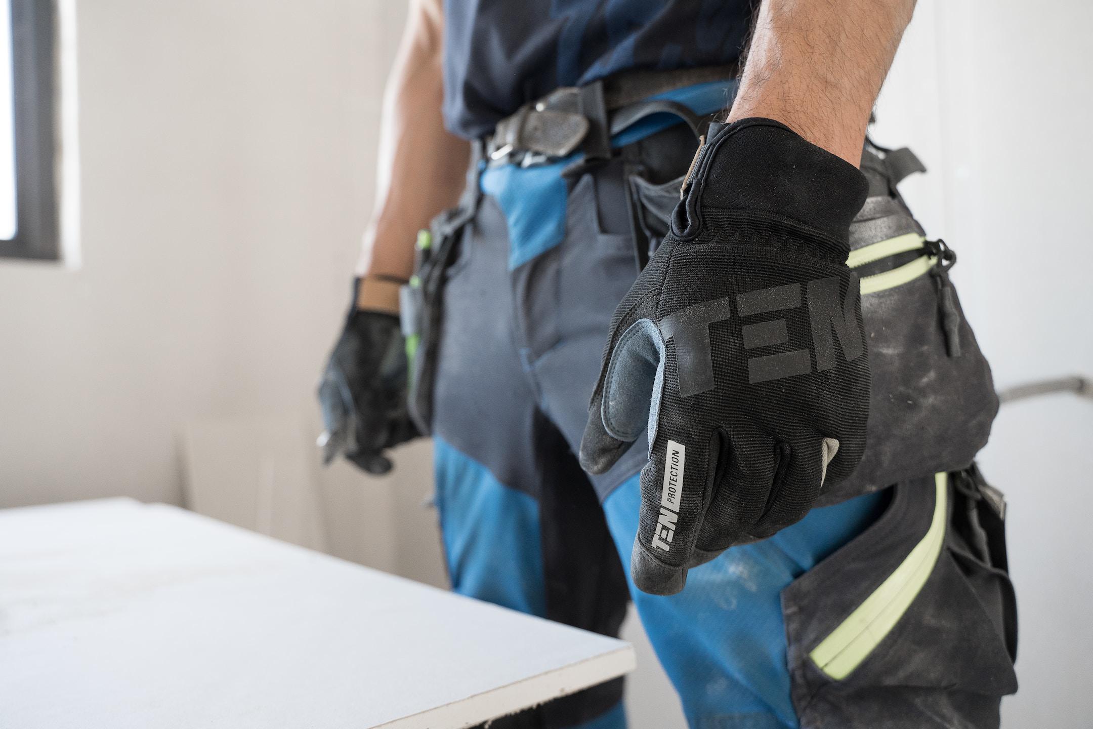 A carpenter with Ten Protection work gloves on waiting to do his work.