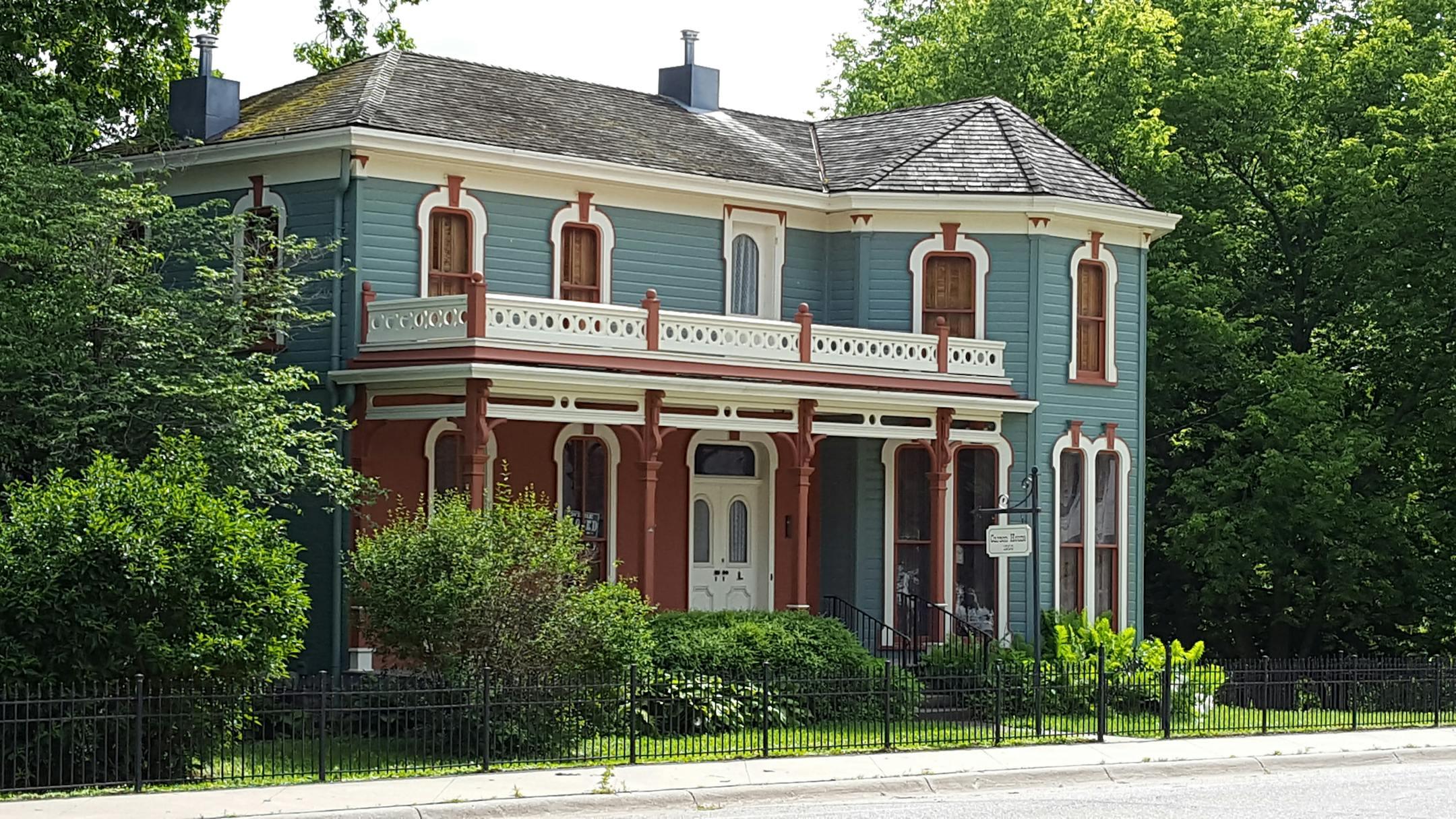 Discover a picturesque Victorian home with a beautifully detailed facade and lush greenery.