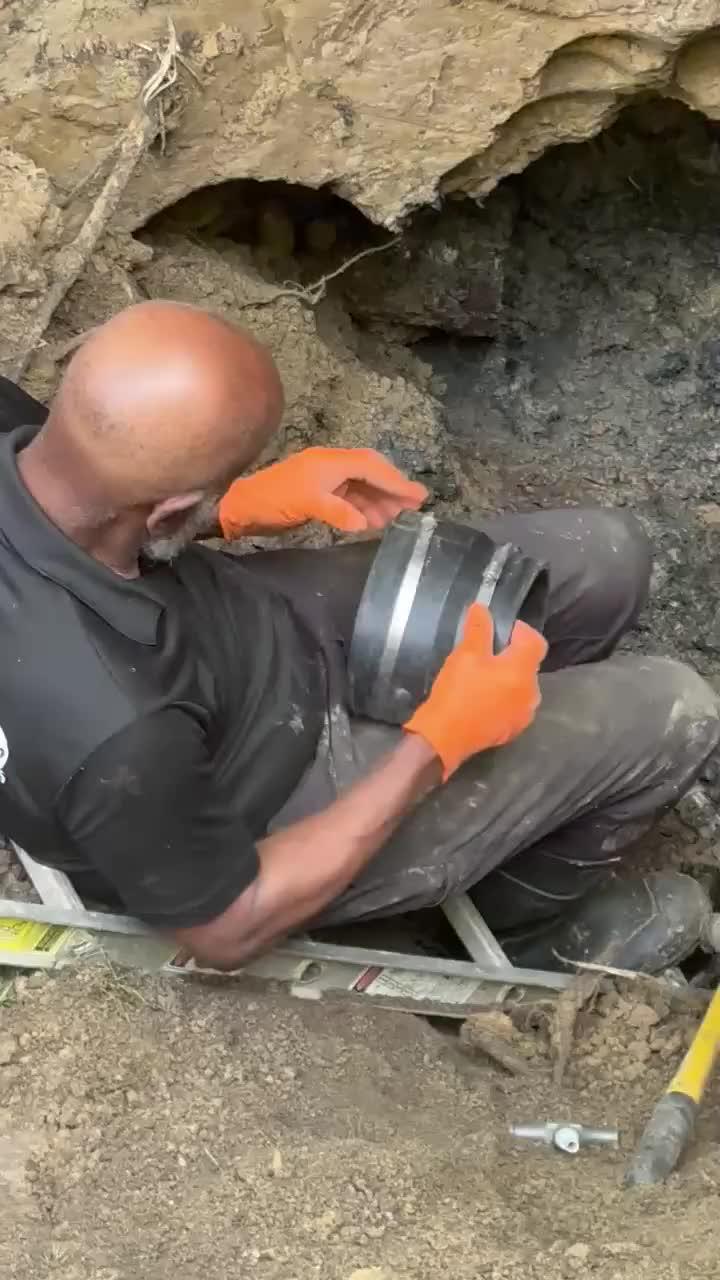 Bryant & Sons team completing outdoor plumbing work for a managed property