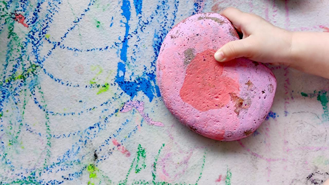 A painted rock in the hands of a child 