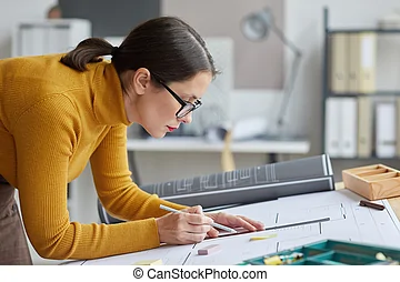 female-architect-at-workplace-side-view-side-view-portrait-of-female-architect-drawing-blueprints-stock-photography_csp86117204.webp