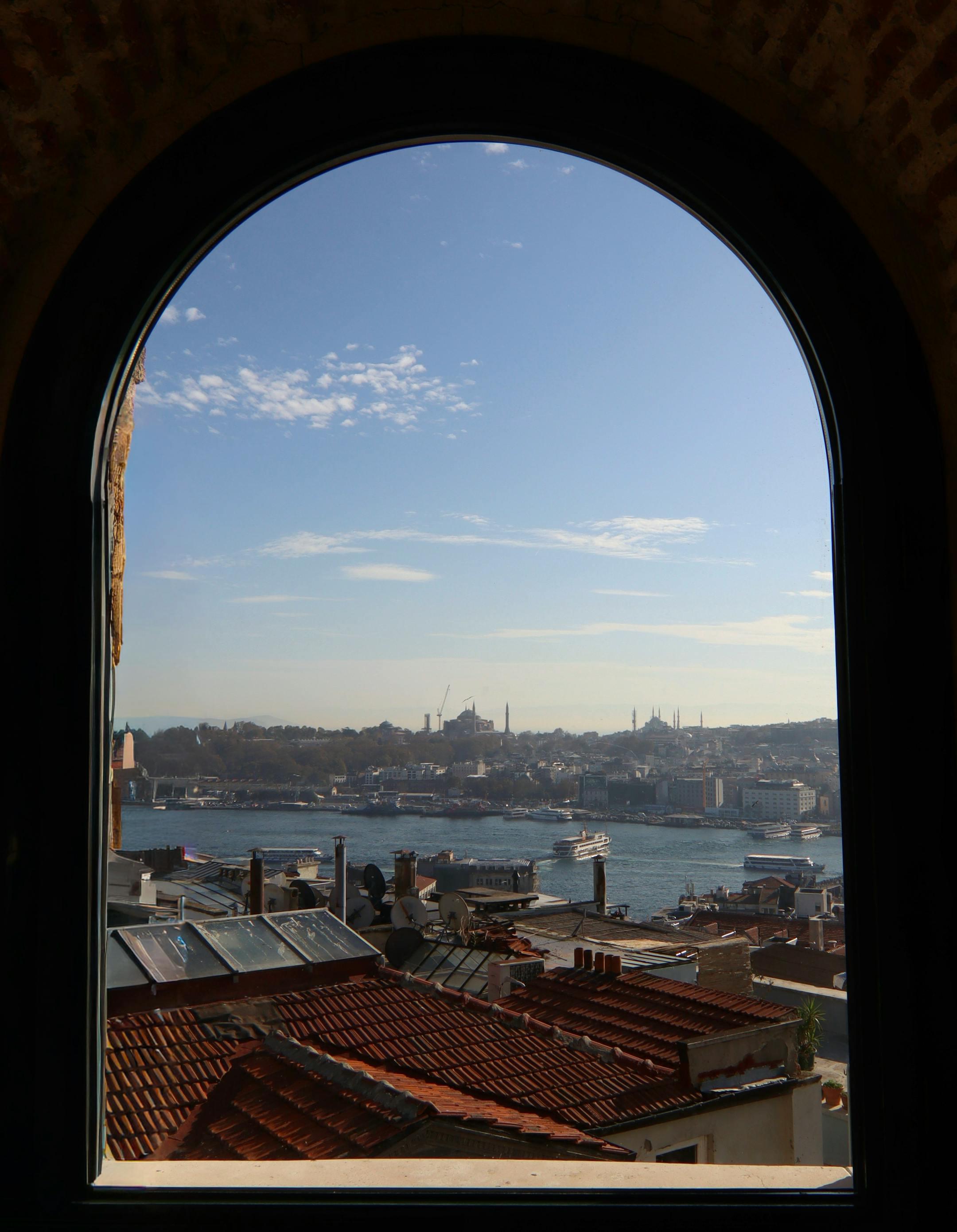 Panoramic view of Istanbul with the Bosphorus through an arched window.