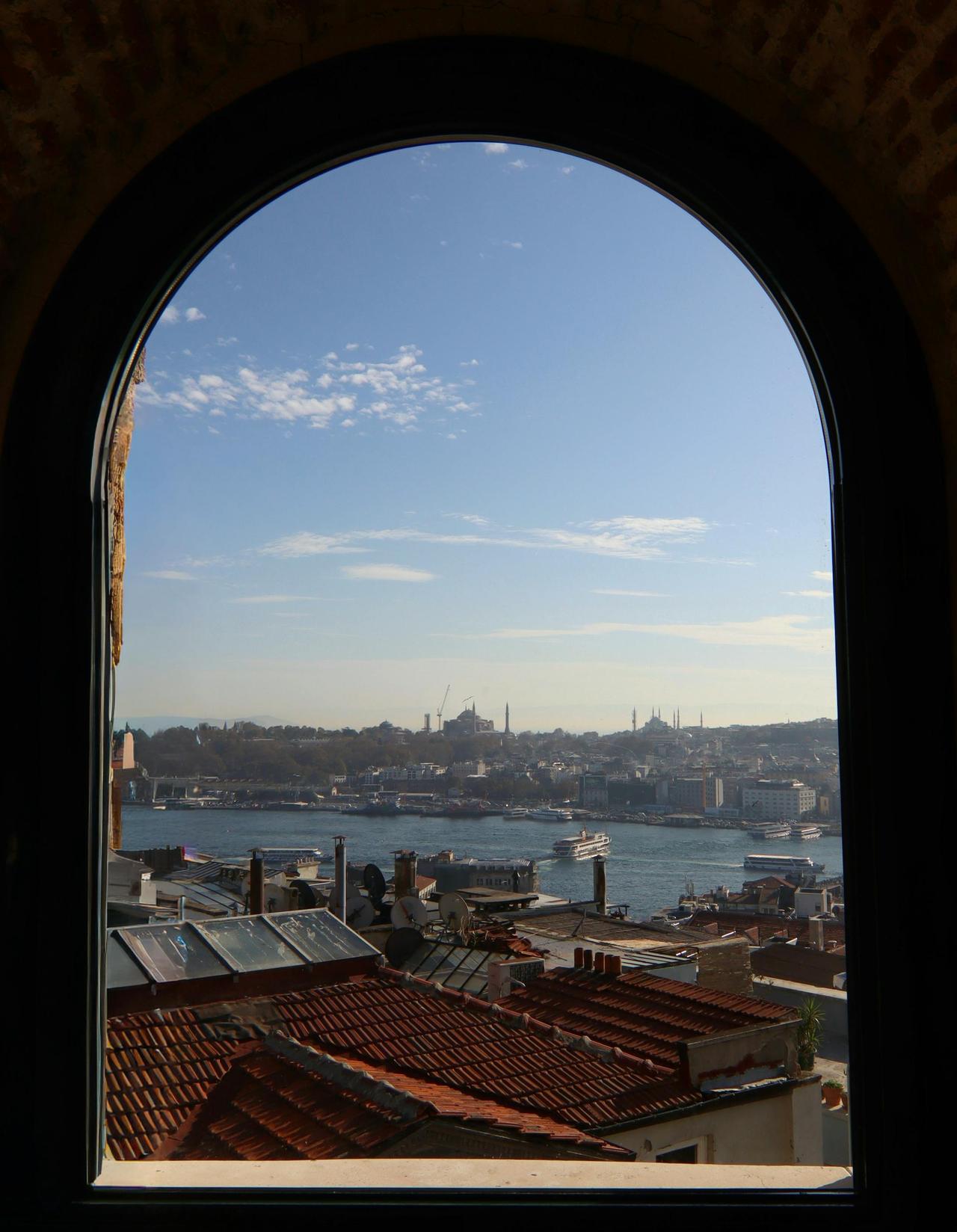 Panoramic view of Istanbul with the Bosphorus through an arched window.