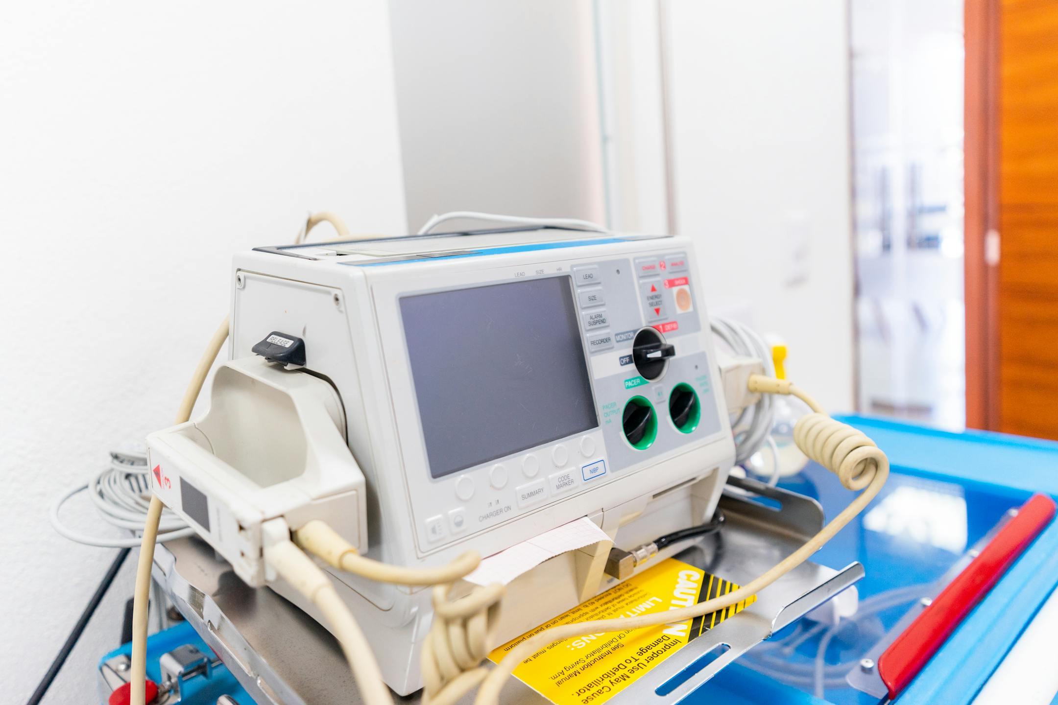 High-resolution image of a modern defibrillator in a hospital environment.