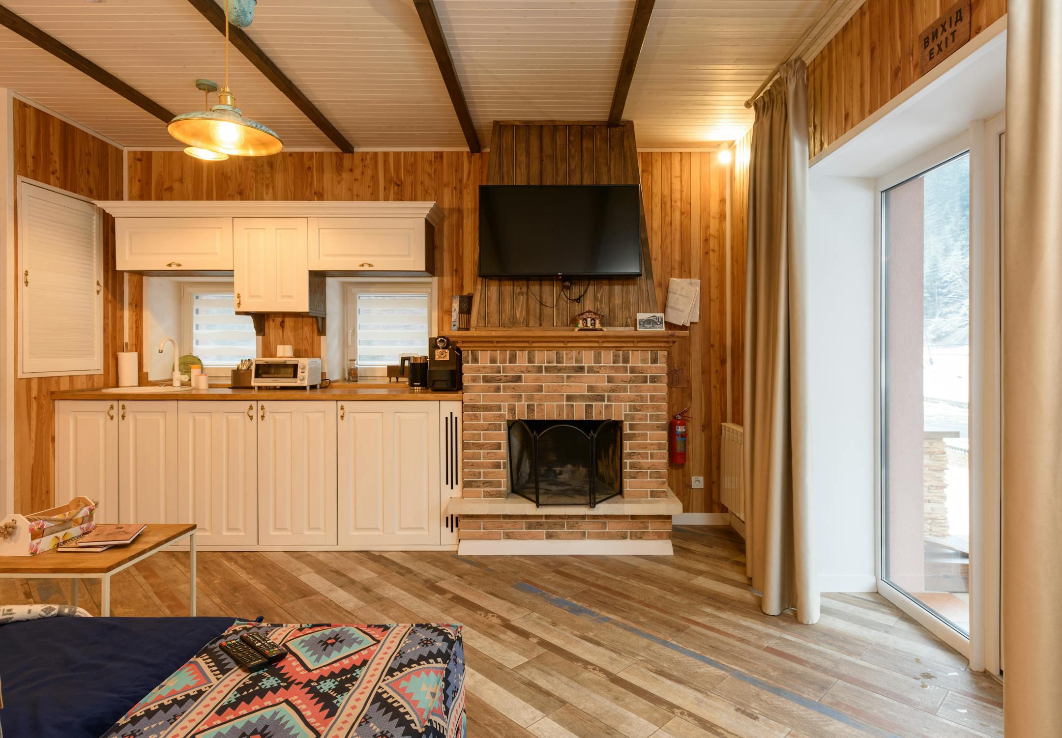 Warm and inviting chalet interior with a wooden finish and a cozy fireplace.