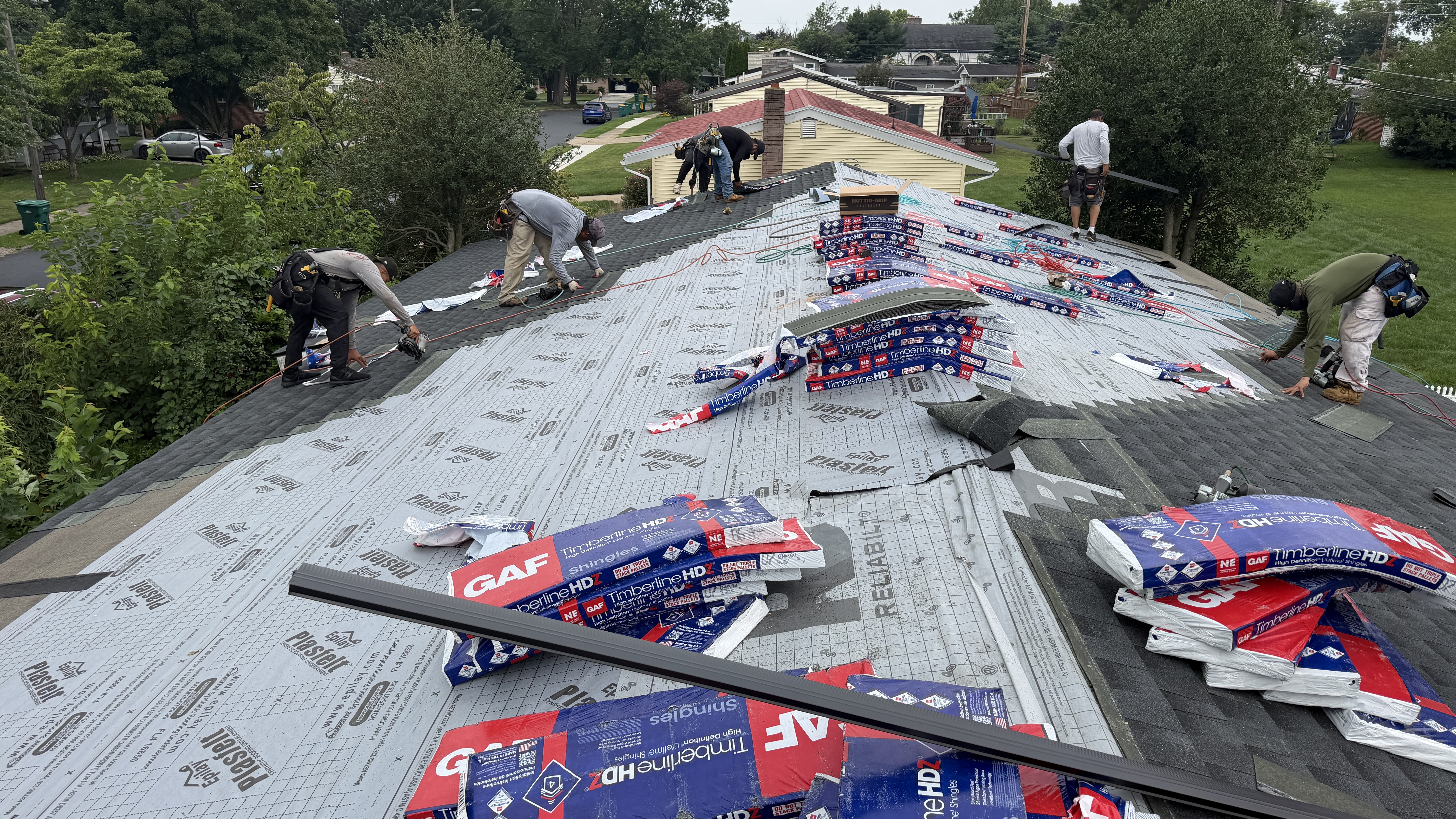 Professional roofing team installing GAF Timberline HDZ shingles with precision and care