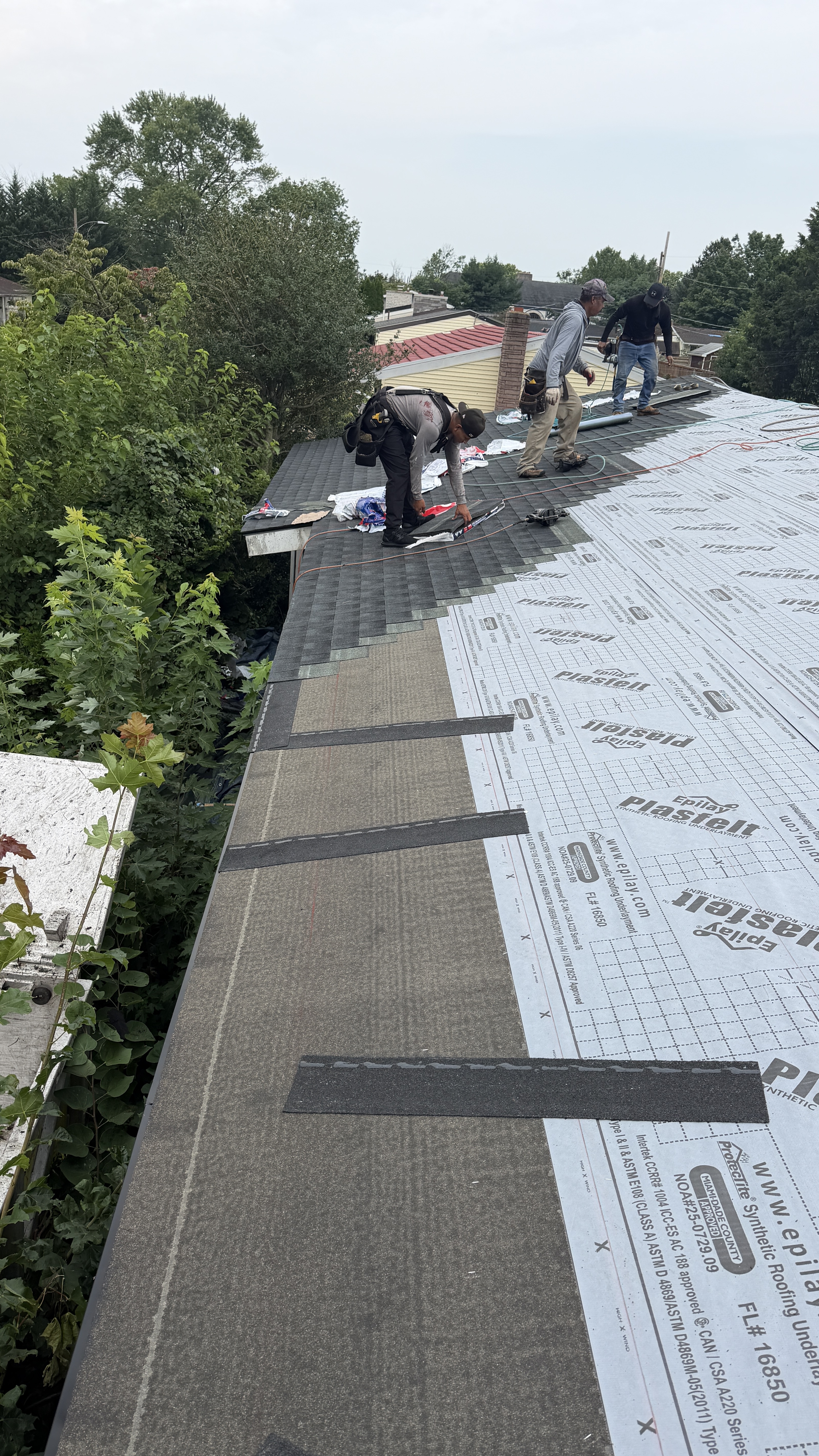 Roofing team demonstrating professional installation techniques and quality workmanship on residential roof