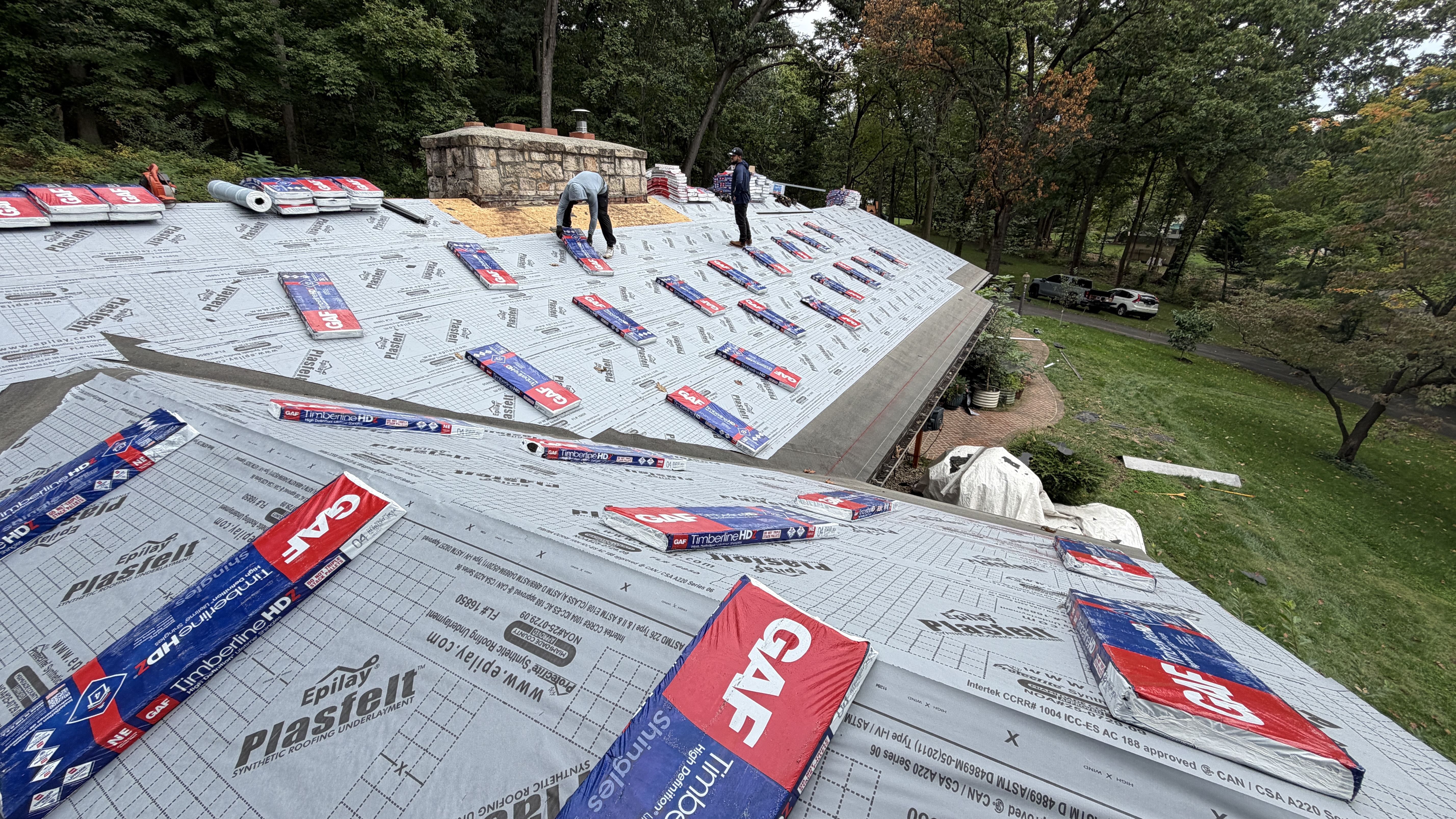 Final result showing the complete roof replacement and new gutter system