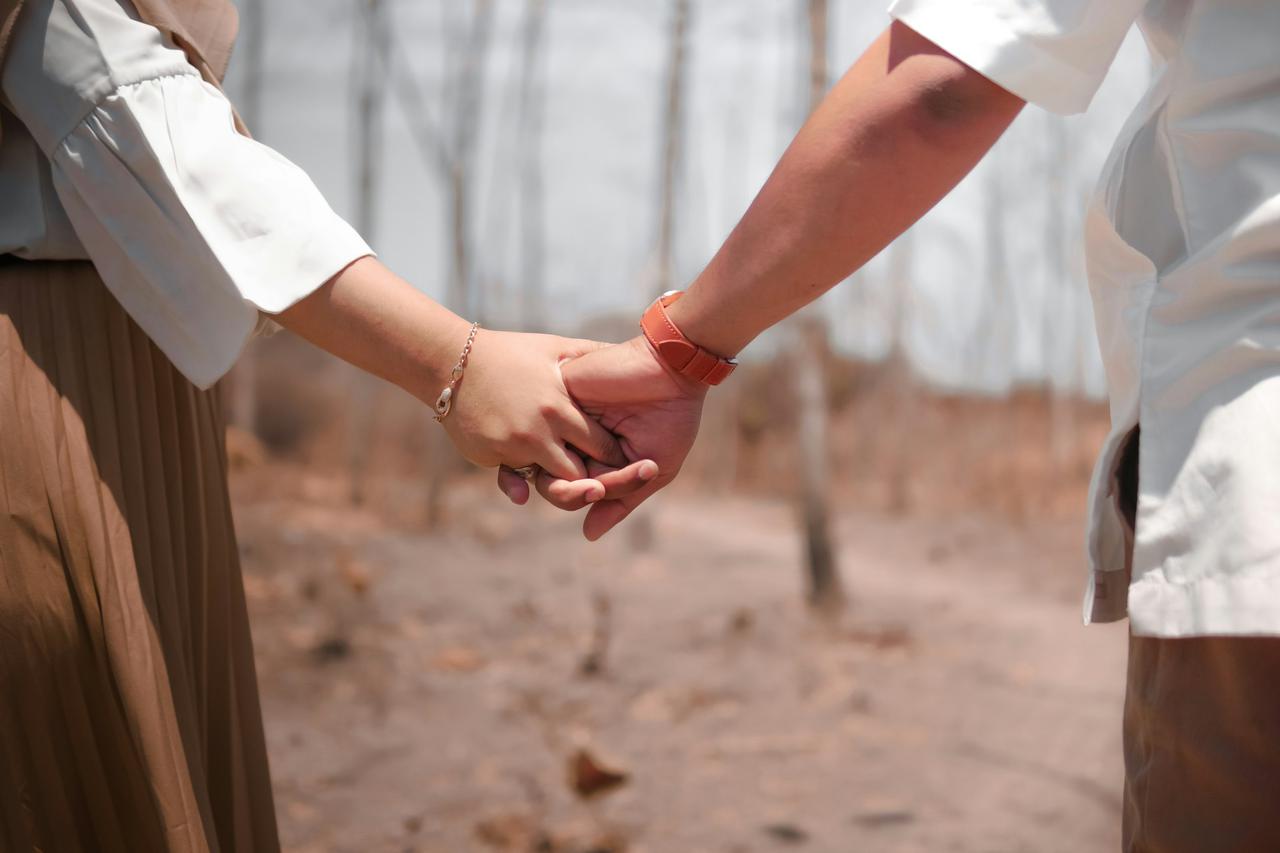 Couple holding hands