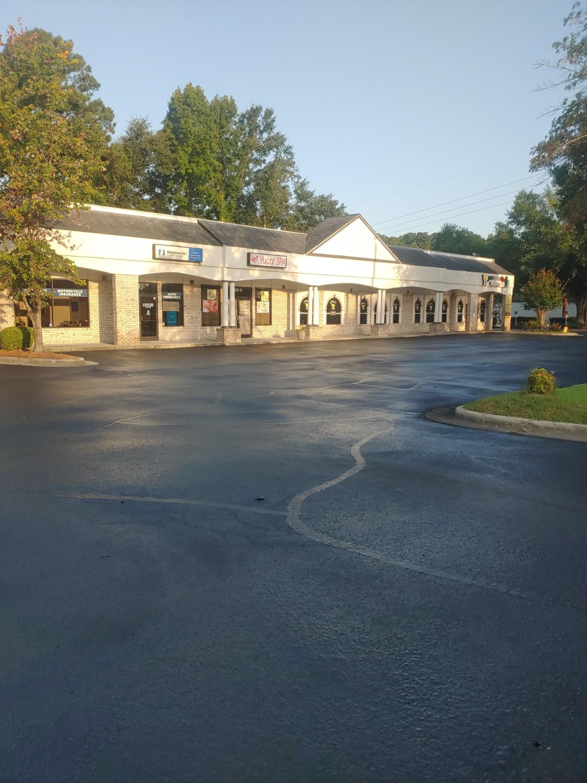 A parking lot with fresh seal coating work done.