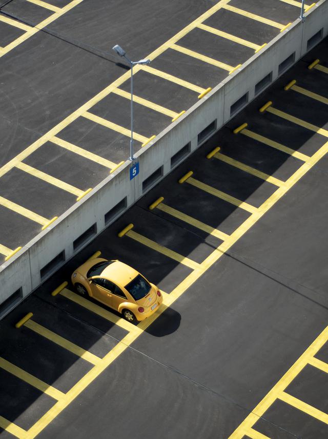 Image of a parking lot that gets regular parking lot asphlat repair.