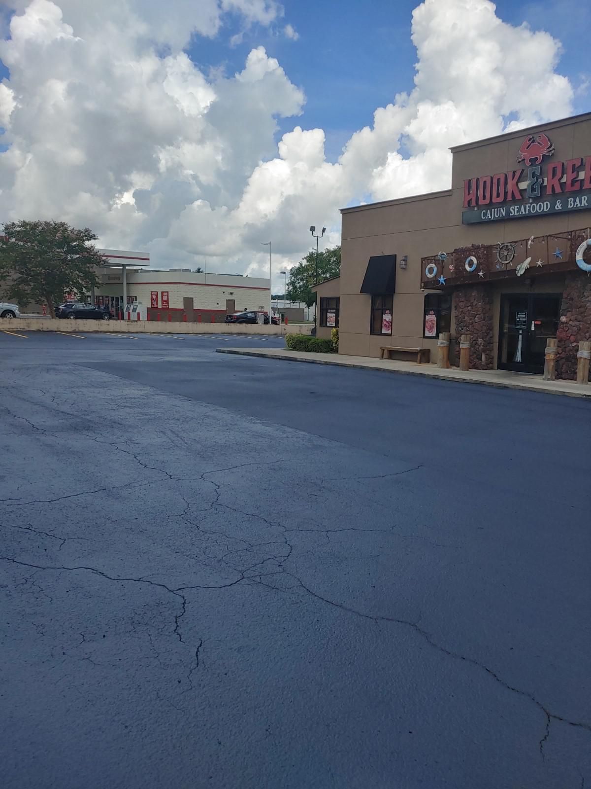 Fresh asphalt repairs outside of a restaurant.