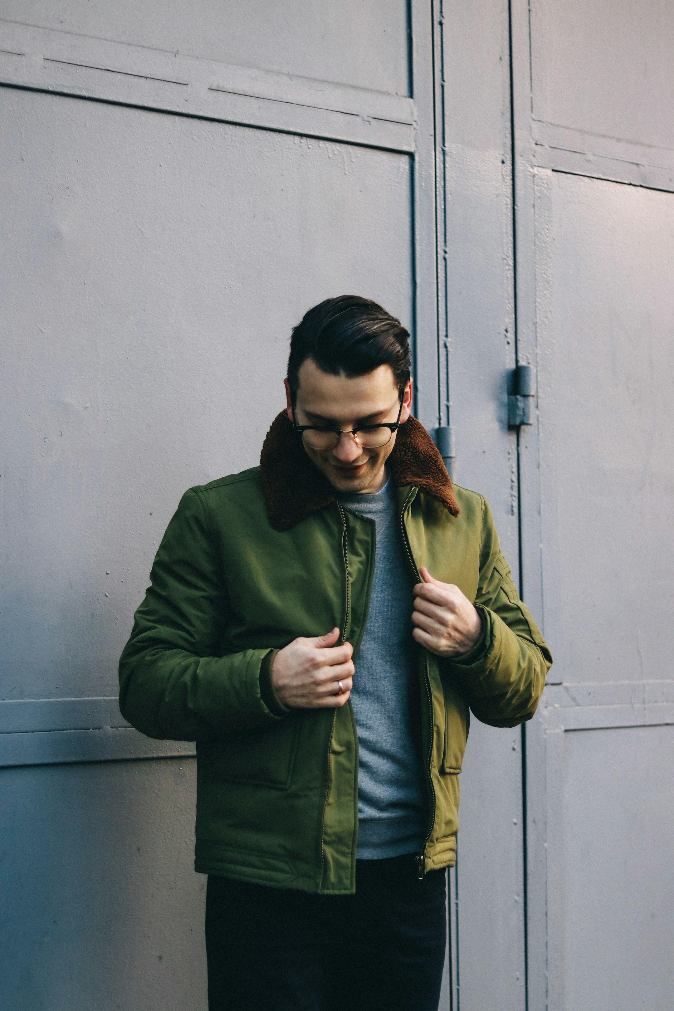 Man in green jacket and glasses