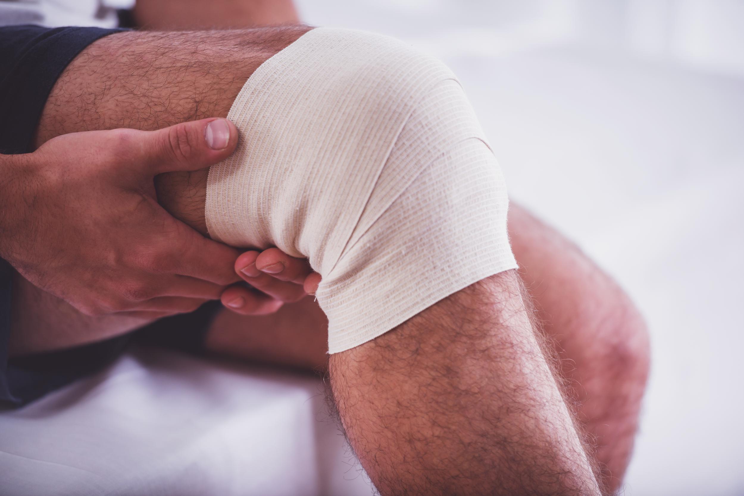 knee-injury-treatment-with-bandage-wrap-support-2026-03-10-04-46-57-utc.jpg