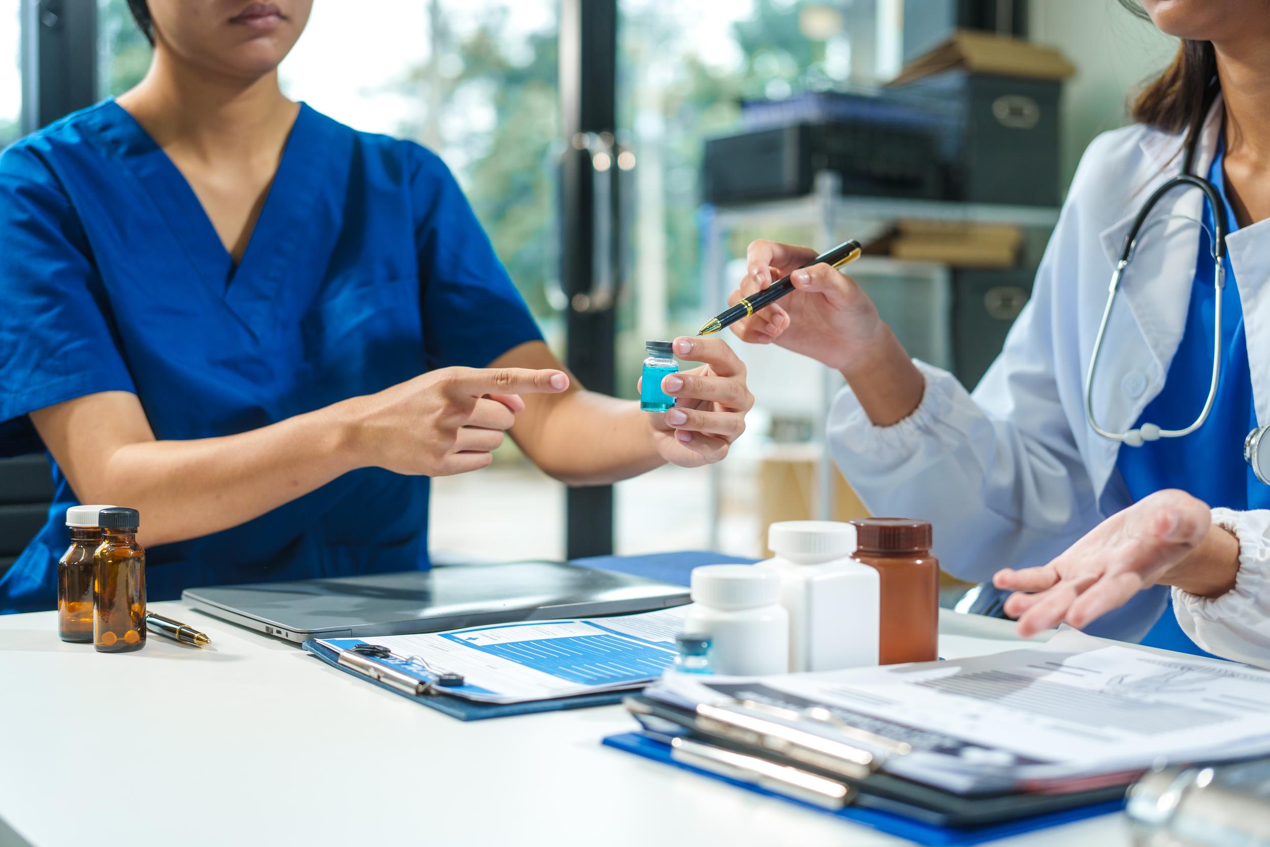 a-close-up-of-two-doctors-discussing-a-bottle-of-m-2026-03-18-17-44-07-utc.jpg