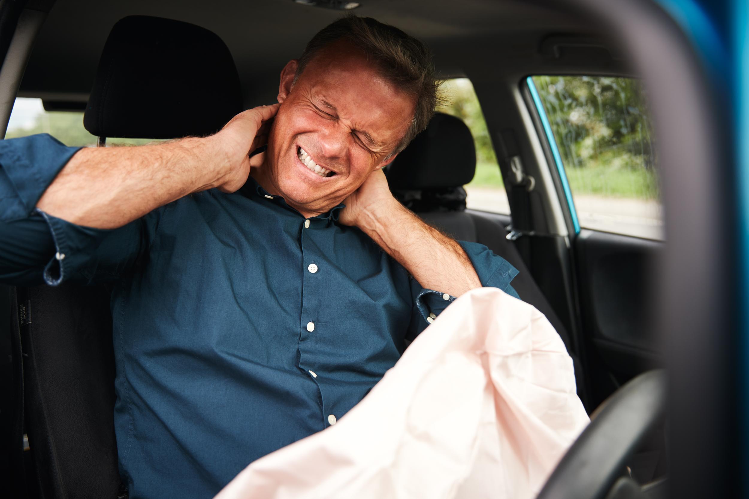 man-in-car-clutching-neck-after-an-accident-2026-01-05-22-54-32-utc.jpg