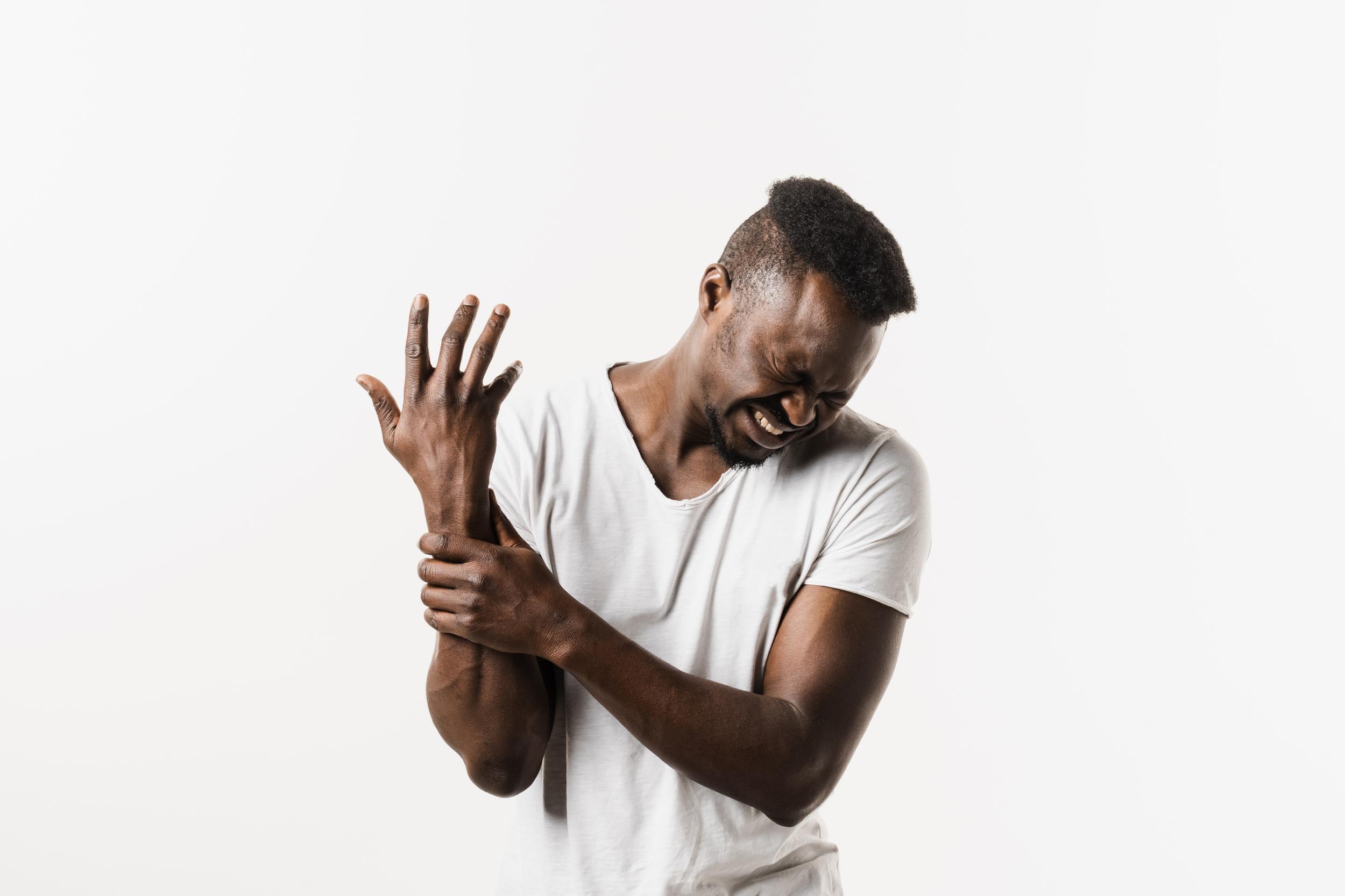 man-feeling-arm-pain-against-white-background-2026-04-04-23-53-40-utc.jpg