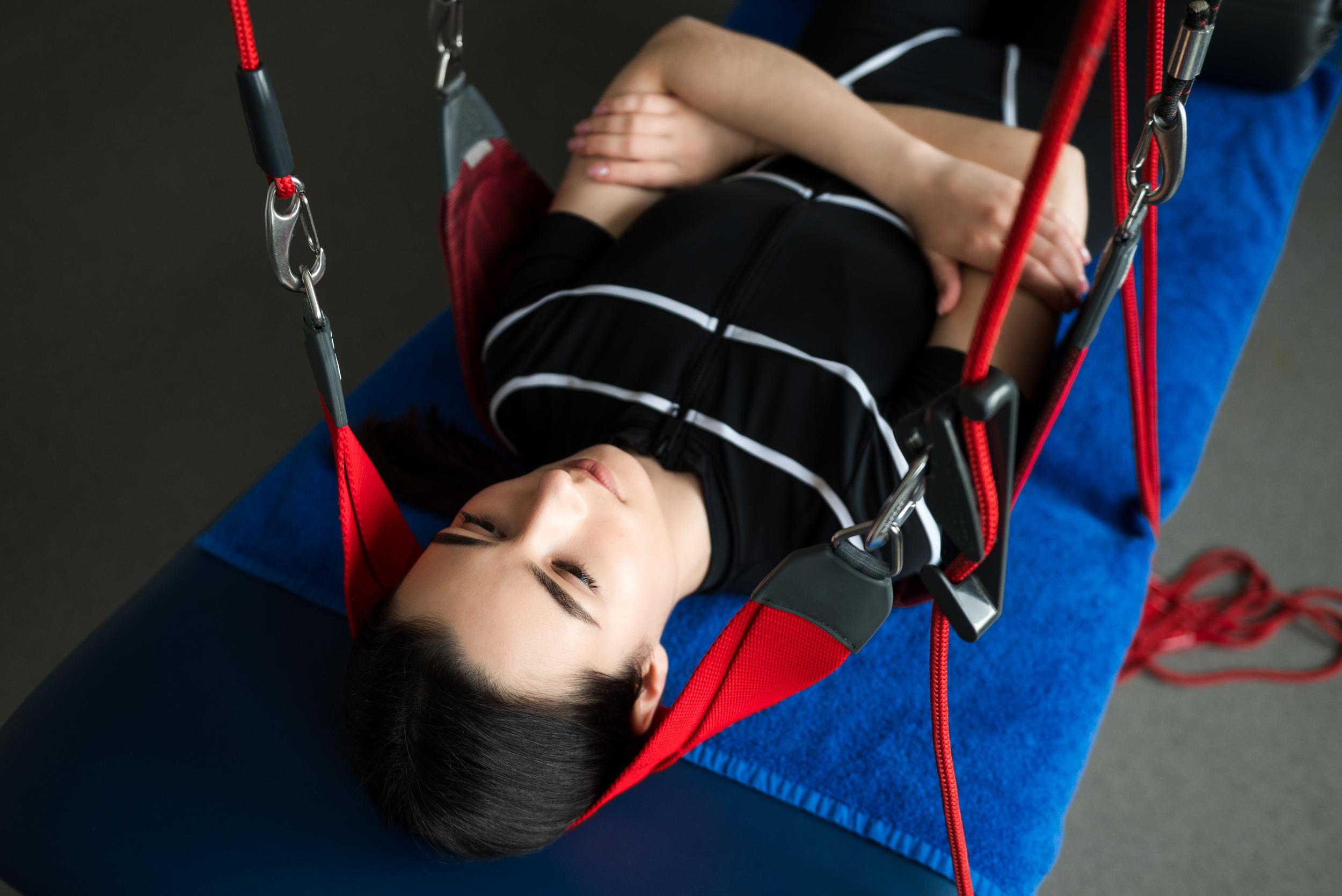 woman-lying-on-table-using-redcord-sling-system-2026-04-04-23-53-51-utc.jpg