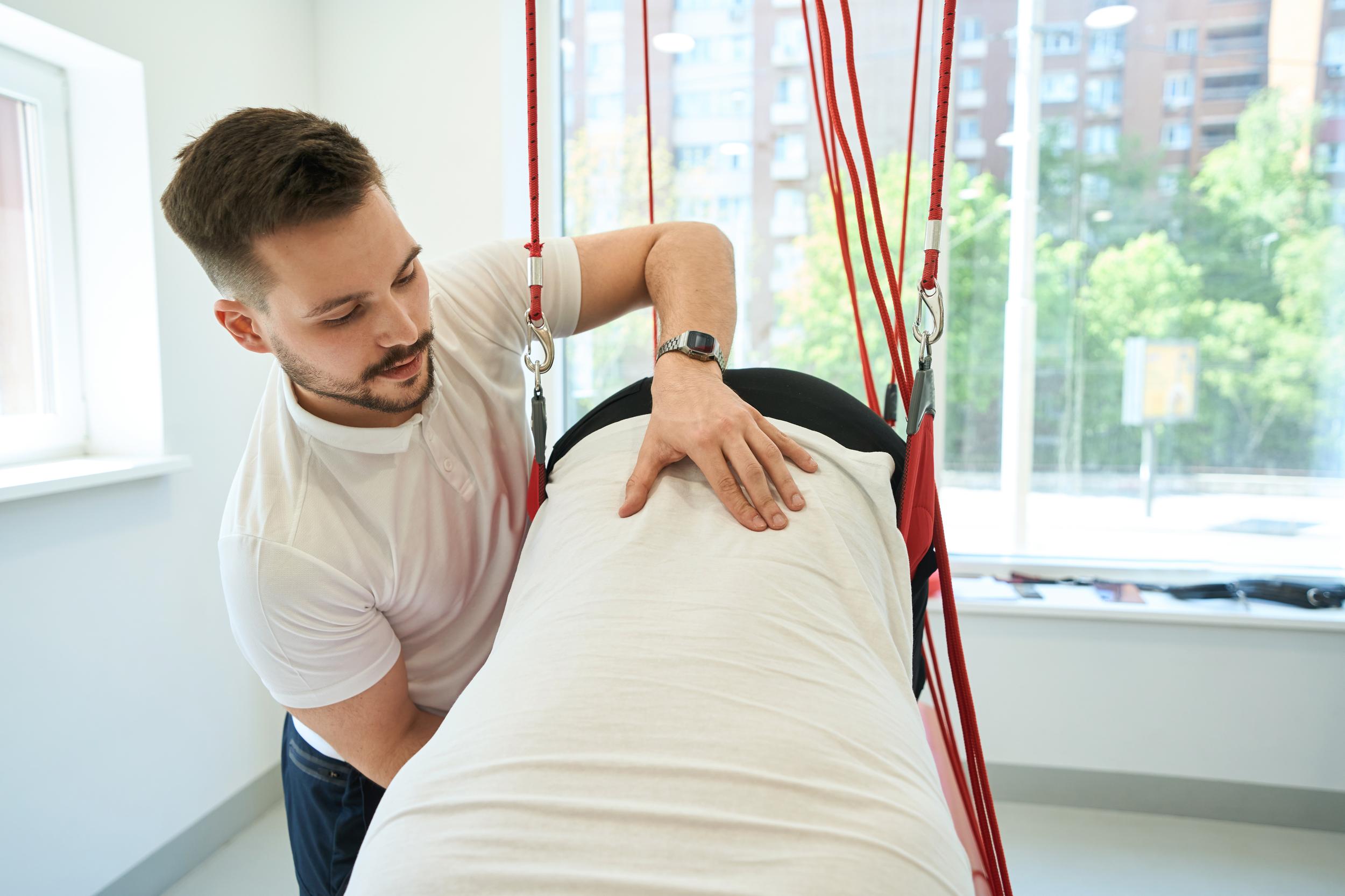 man-helping-person-in-suspension-therapy-setting-2026-03-10-04-48-39-utc.jpg