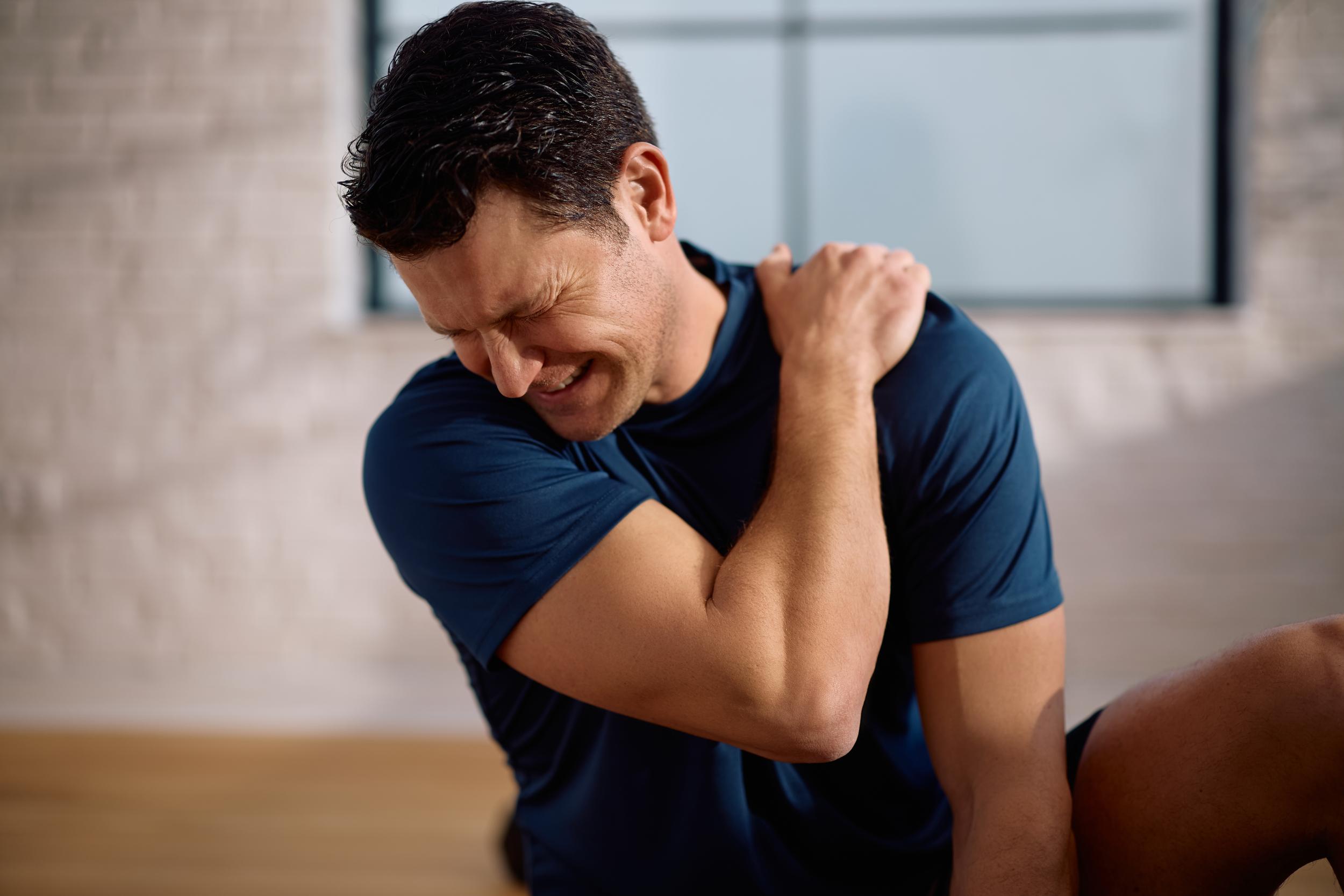 man-clenching-shoulder-from-pain-in-home-2026-03-25-03-59-01-utc.jpg