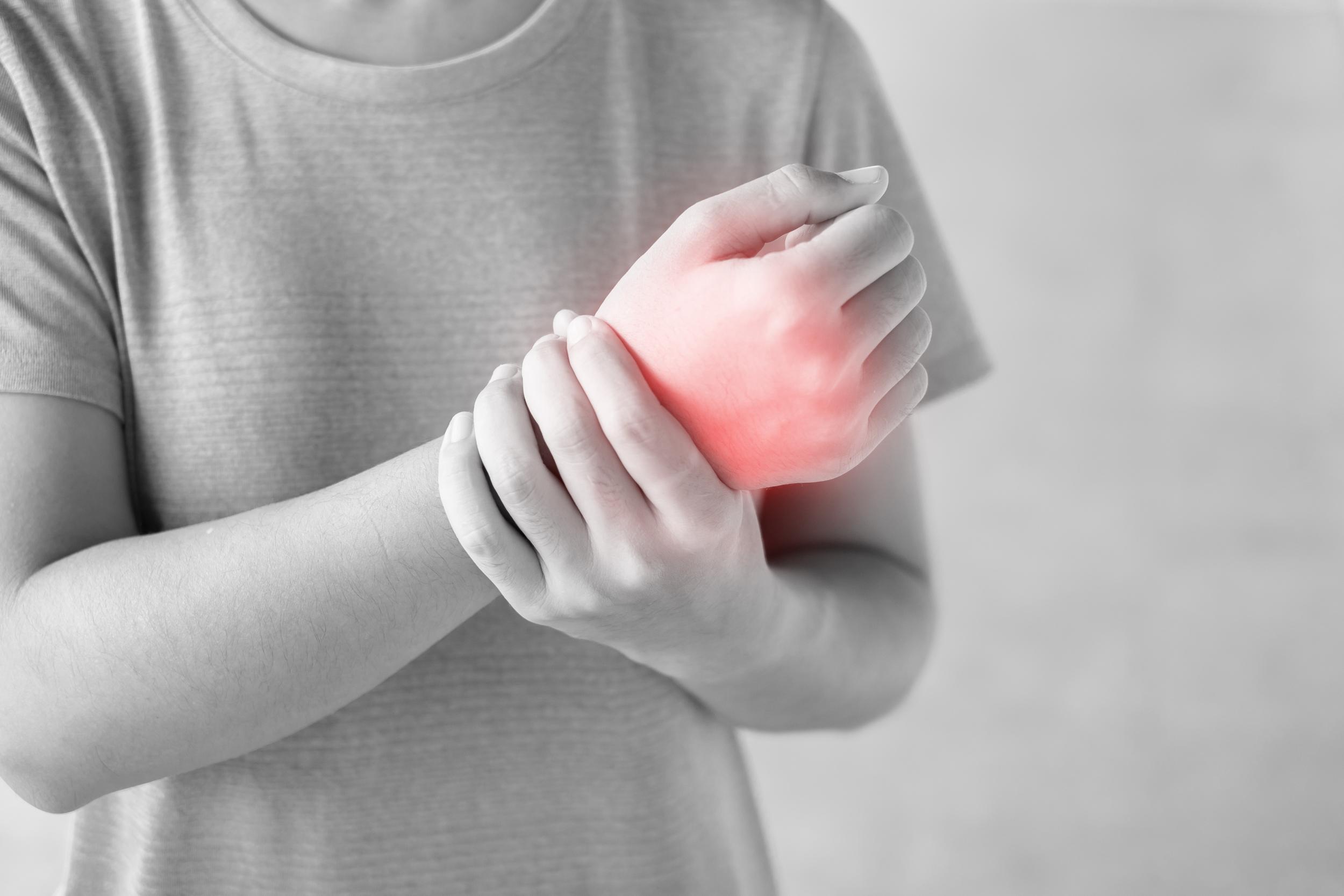 adult-with-painful-wrist-condition-holding-hand-2026-03-20-01-00-17-utc.jpg