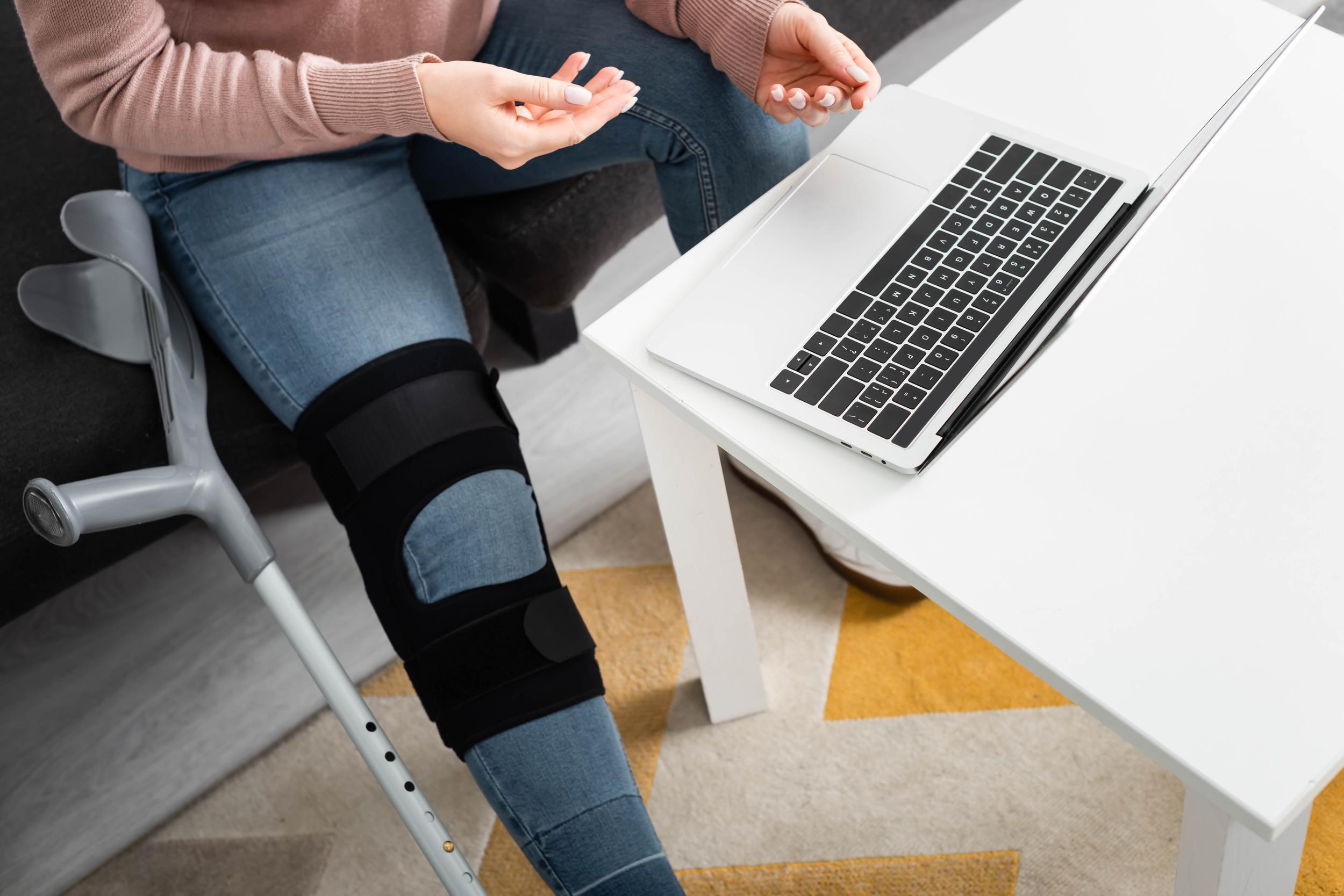 cropped-view-of-woman-with-broken-leg-having-onlin-2026-03-11-06-52-41-utc.jpg