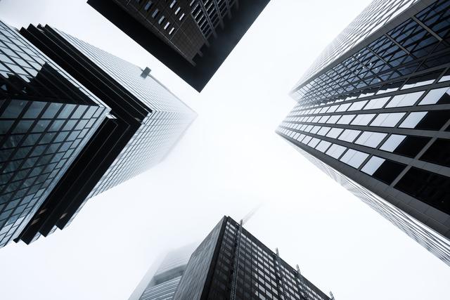Looking up to Frankfurt's impressive skyscrapers during a foggy morning. 