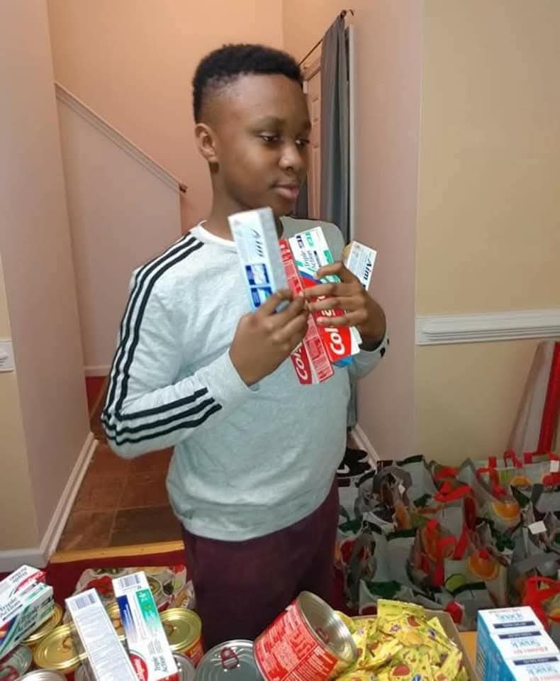 Young volunteer helping gather food donations