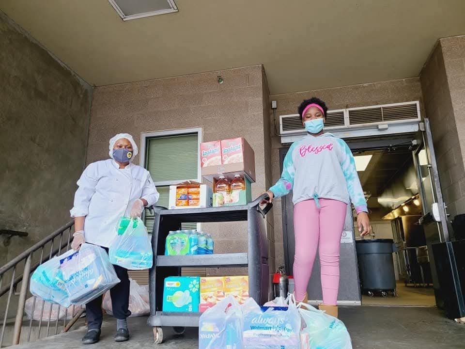 Community volunteers organizing food and essential supplies