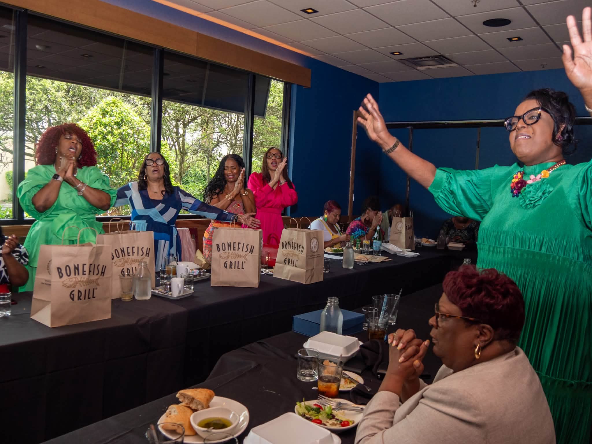 Women participating in a moment of prayer and encouragement