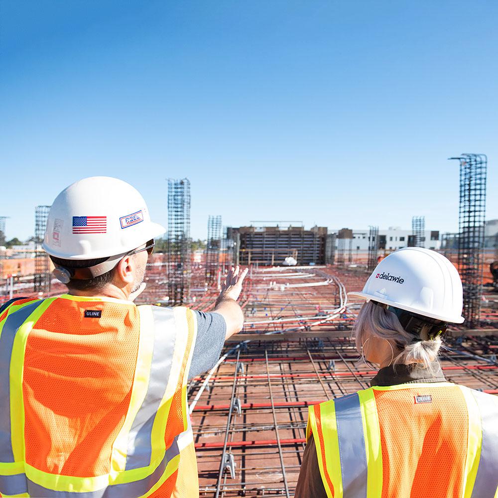 Two people looking at a construction site.