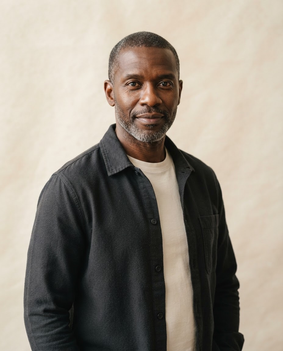 Marcus Bell, close-cropped salt-and-pepper-haired man with a neat beard in a charcoal overshirt.